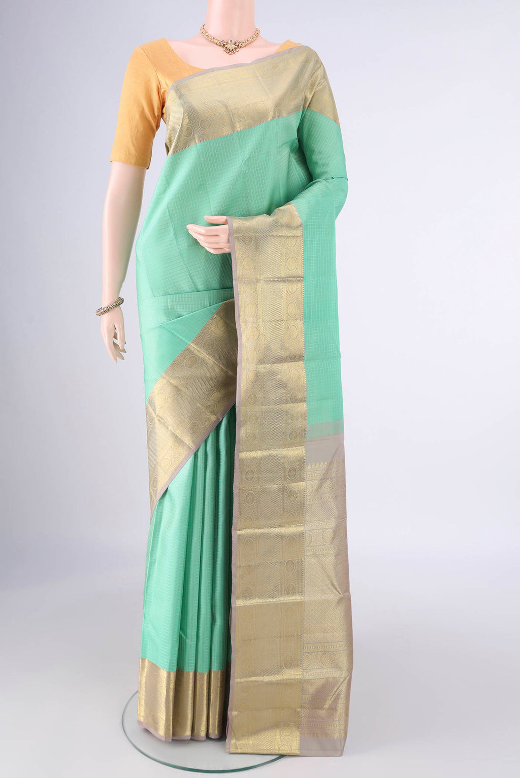 Pure Silk Acid Green Kanjivaram Saree with Checked design on the body and Zari Border.  displayed on a mannequin