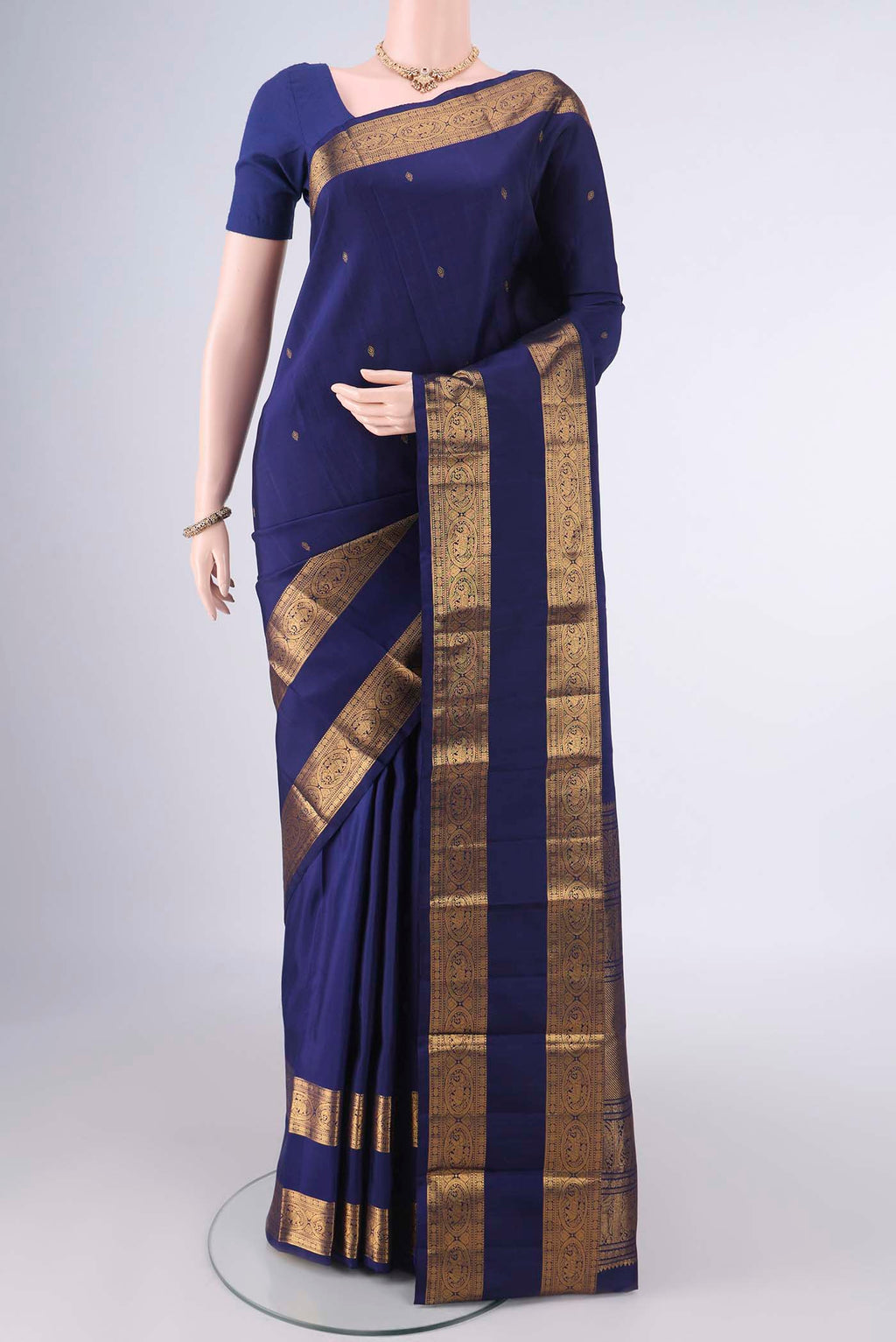 Pure Silk Dark Blue Kanchipuram Saree with Zari Butta on the body and Zari Border.  displayed on a mannequin