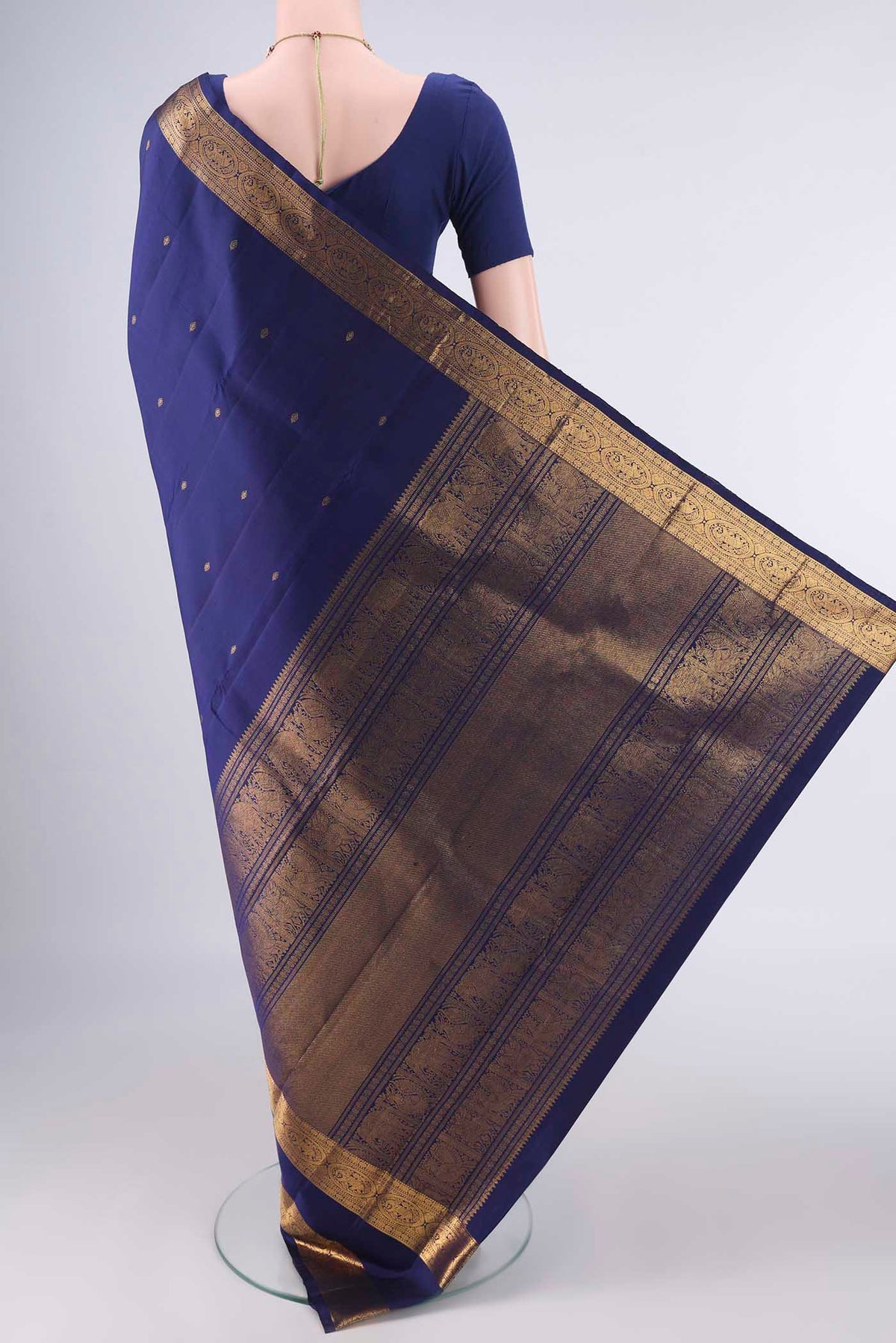 Flat view of Pure Silk Dark Blue Kanchipuram Saree with Zari Butta on the body and Zari Border. 