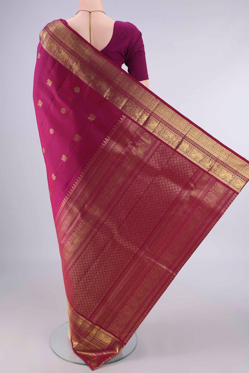 Flat view of Pure Silk Magenta Kanjivaram Saree with Zari Butta on the body and Zari Border. 