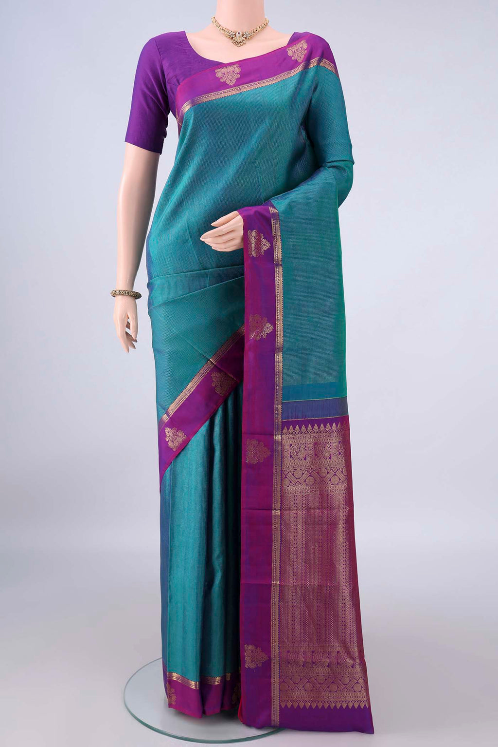 Pure Silk Peacock Blue Dual Tone Kanjivaram Saree with Stripes on the body and Zari Border.  displayed on a mannequin