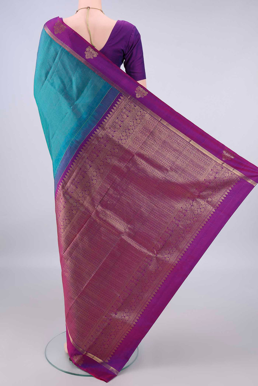 Flat view of Pure Silk Peacock Blue Dual Tone Kanjivaram Saree with Stripes on the body and Zari Border. 