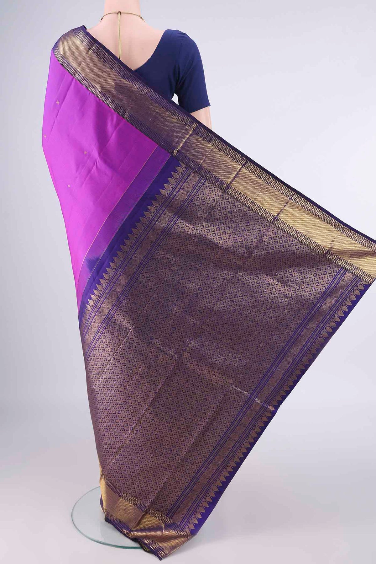 Flat view of Pure Silk Magenta Kanjivaram Saree with Zari Butta on the body and Zari Border. 