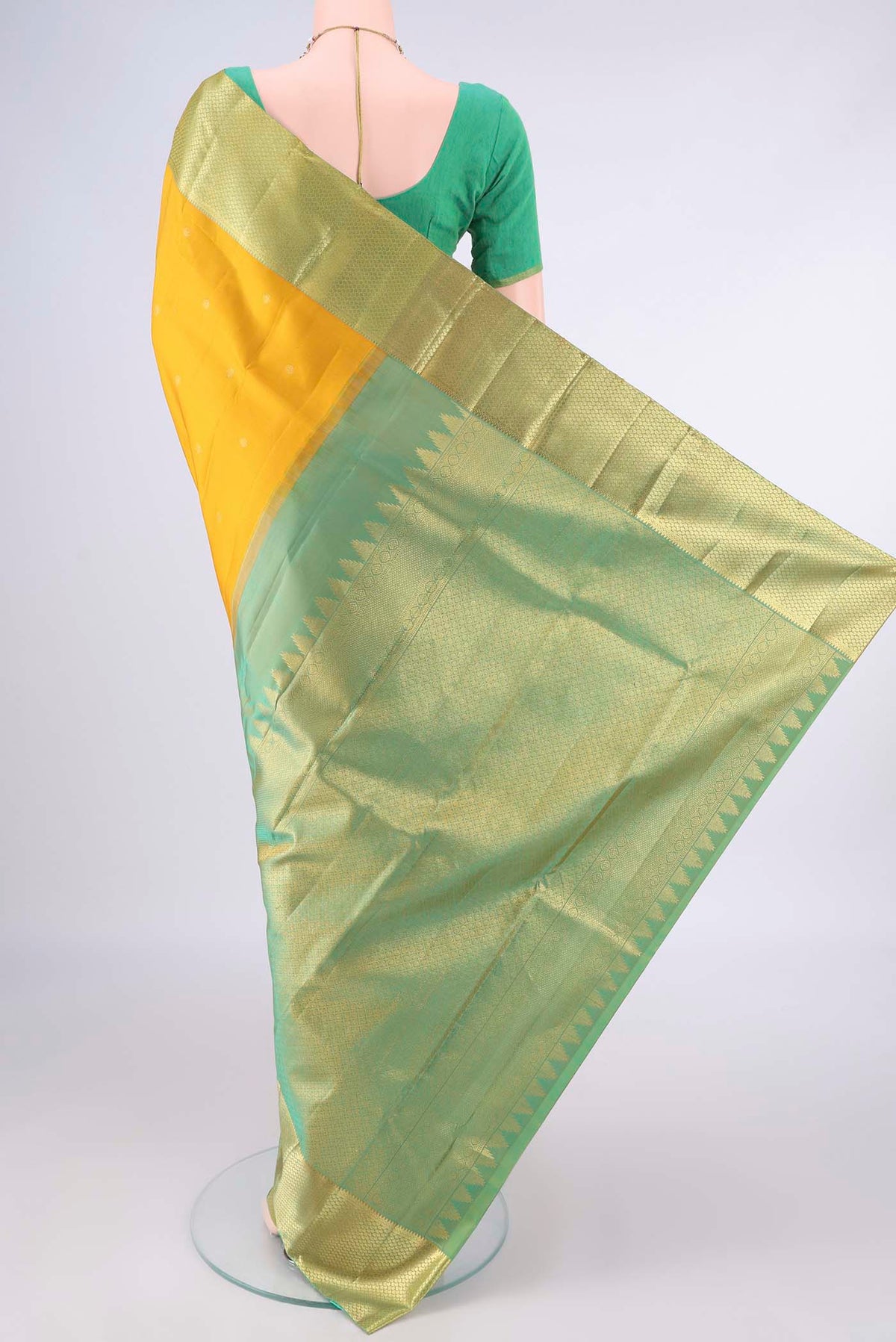 Flat view of Pure Silk Mustard Kanchipuram Saree with Zari Butta on the body and Zari Border. 