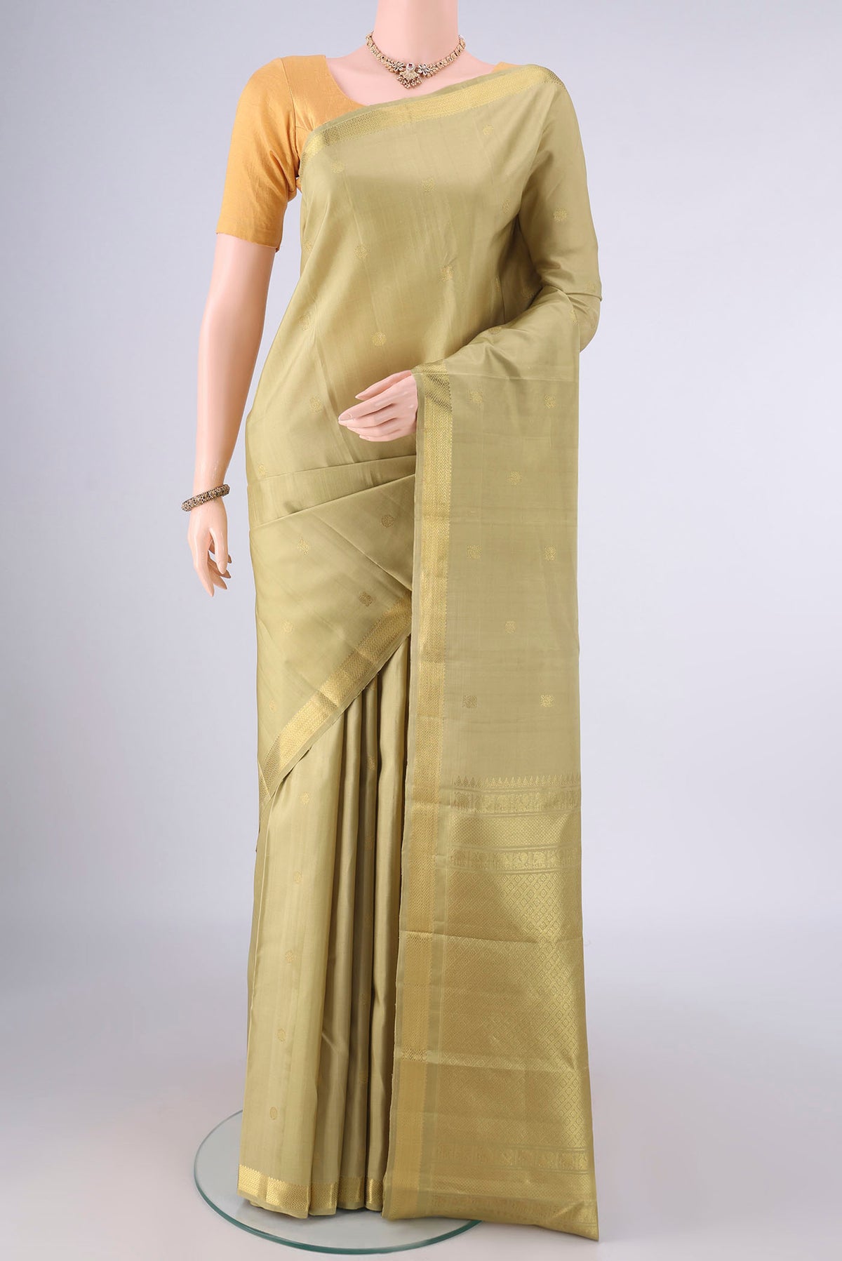 Pure Silk Beige Dual Tone Kanchipuram Saree with Zari Butta on the body and Zari Border.  displayed on a mannequin