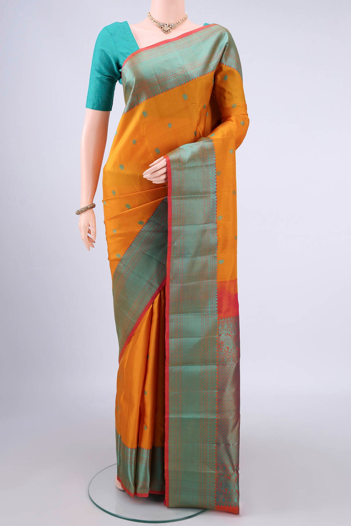 Pure Silk Mustard Kanchipuram Saree with Thread Butta on the body and Thread Border.  displayed on a mannequin