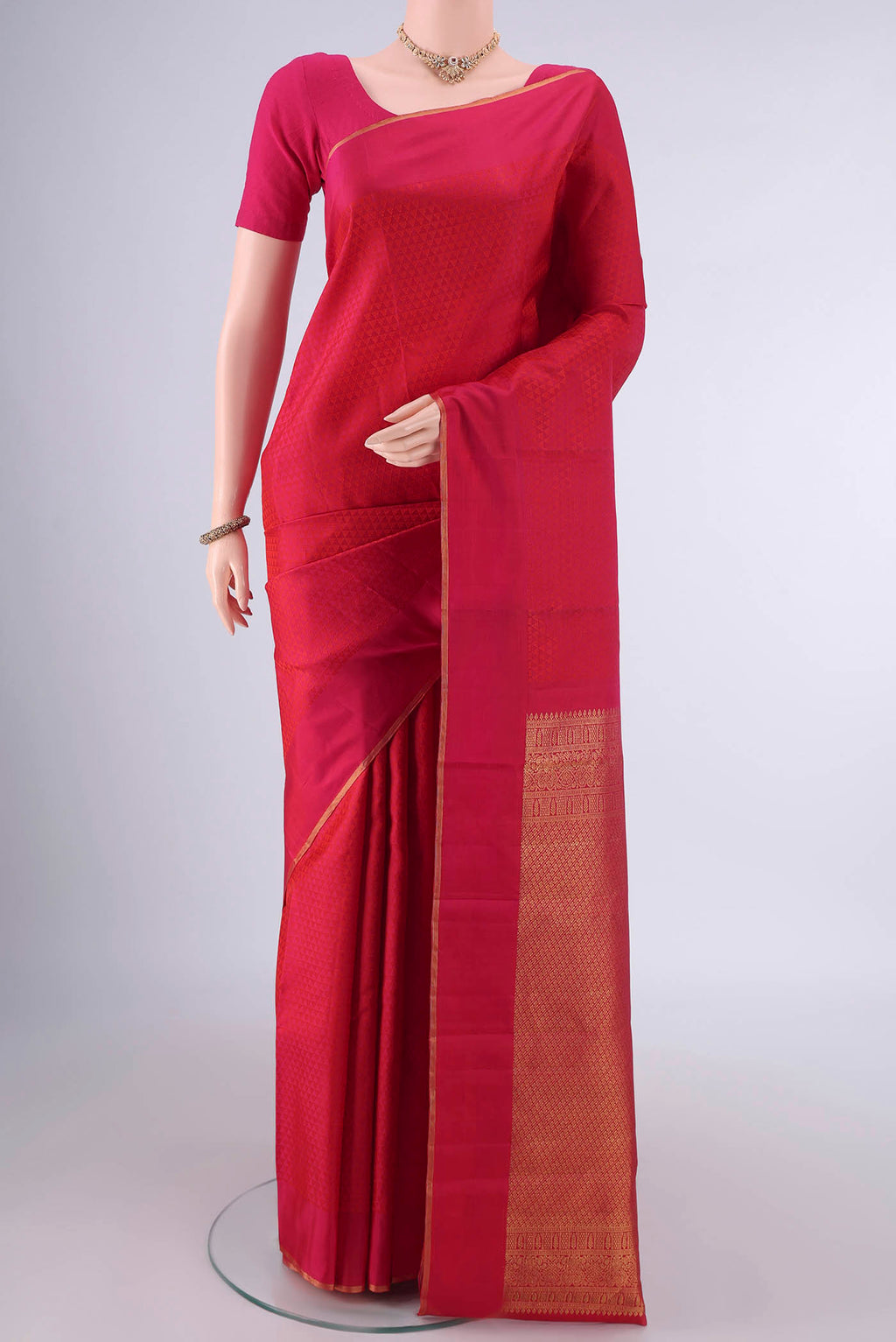 Pure Silk Dark Pink Kanjivaram Saree with Jacquard design on the body and Zari Border.  displayed on a mannequin