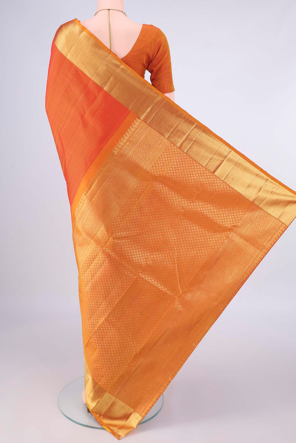 Flat view of Pure Silk Orange Kanjivaram Saree with Jacquard design on the body and Zari Border. 