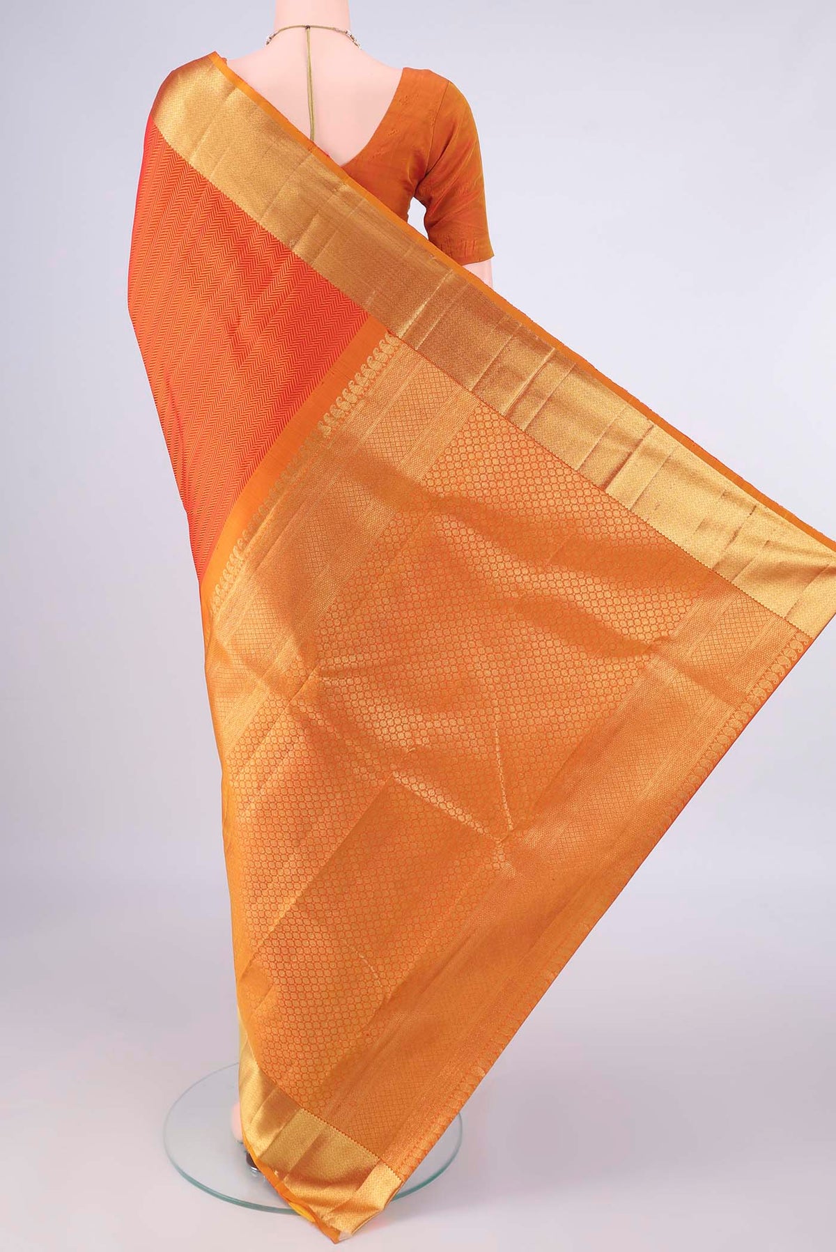 Flat view of Pure Silk Orange Kanjivaram Saree with Jacquard design on the body and Zari Border. 