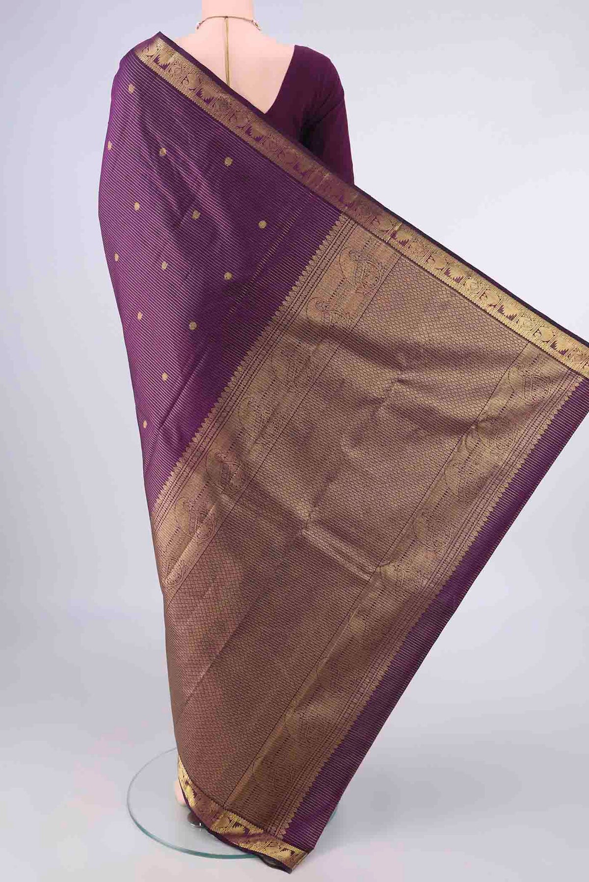 Flat view of Pure Silk Purple Kanchipuram Saree with Zari Butta on the body and Zari Border. 
