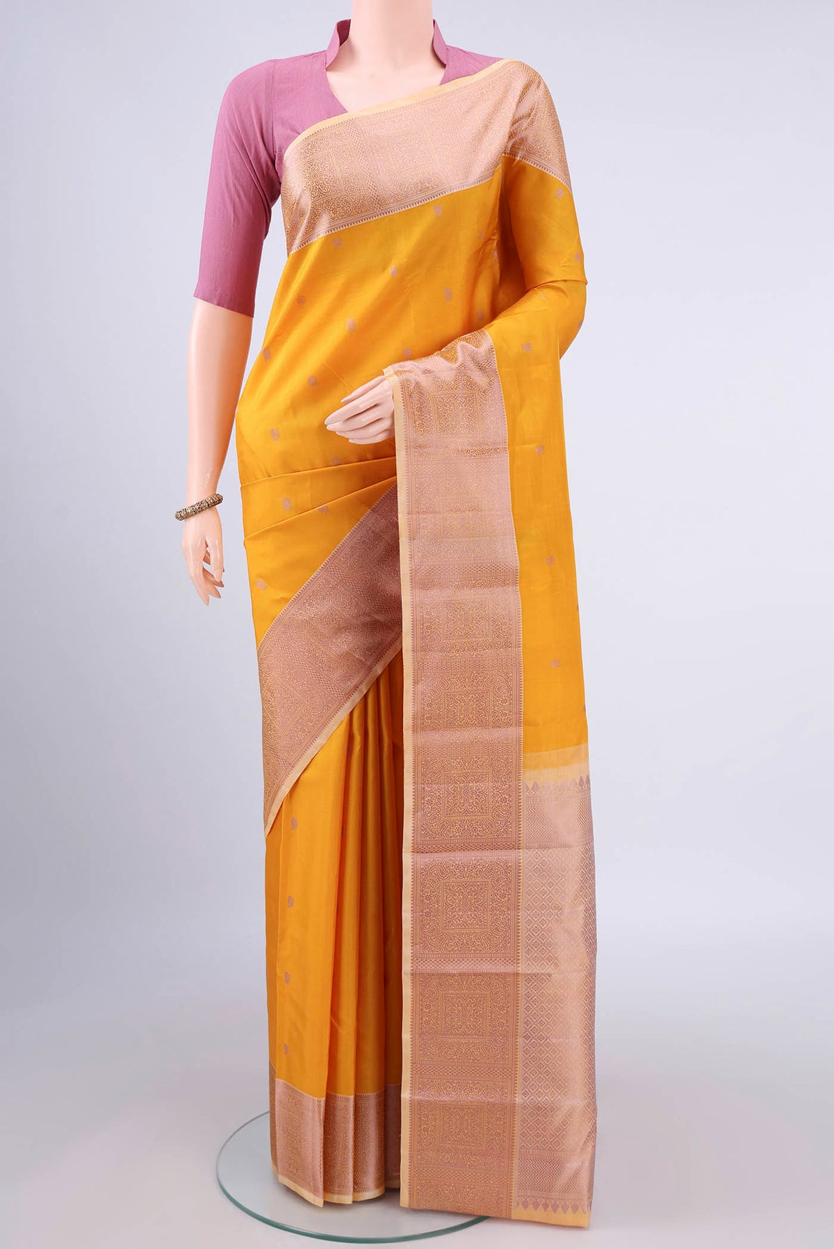 Pure Silk Mustard Kanchipuram Saree with Thread Butta on the body and Thread Border.  displayed on a mannequin