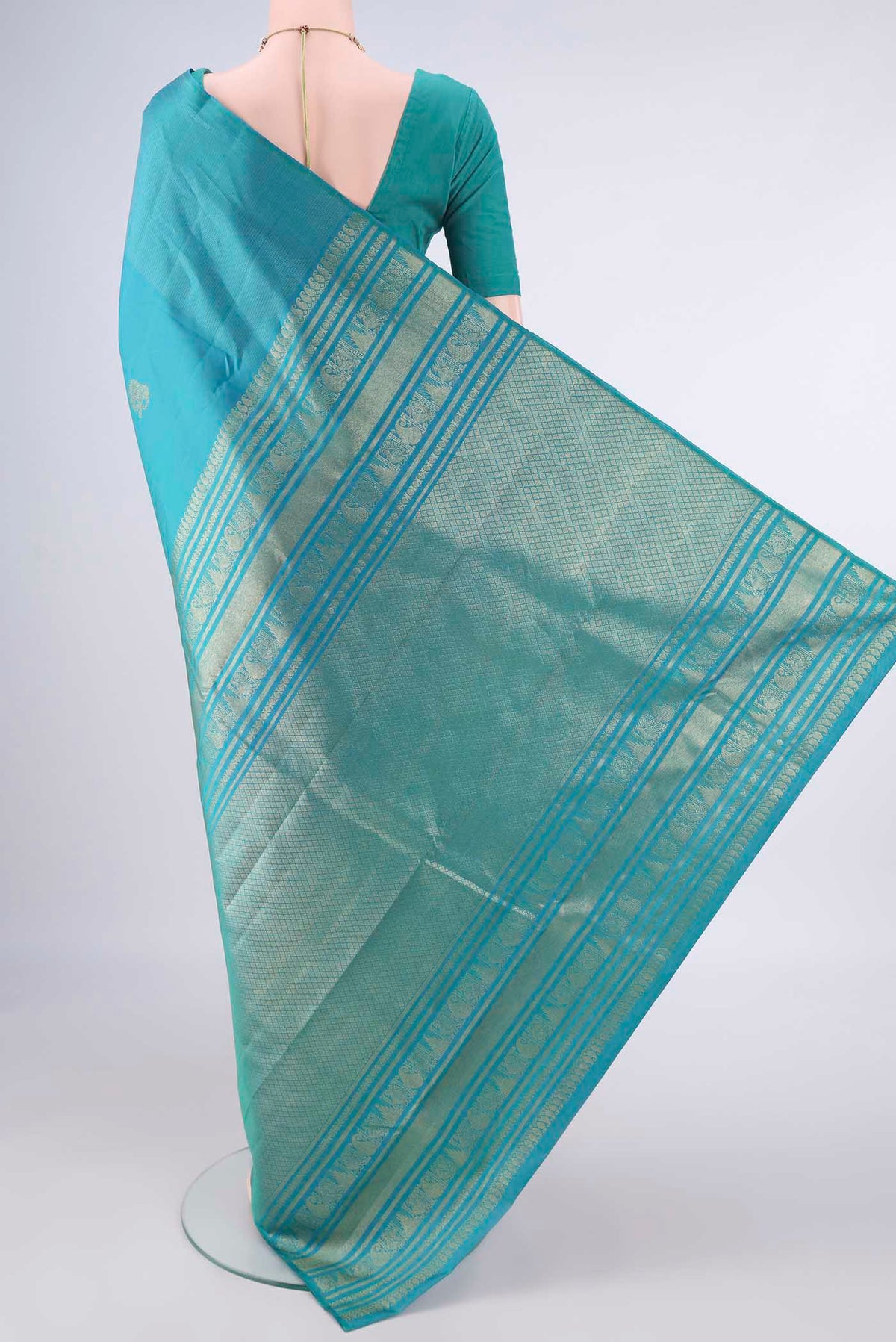 Flat view of Pure Silk Turquoise Dual Tone Kanjivaram Saree with Zari Butta on the body and Without Border. 