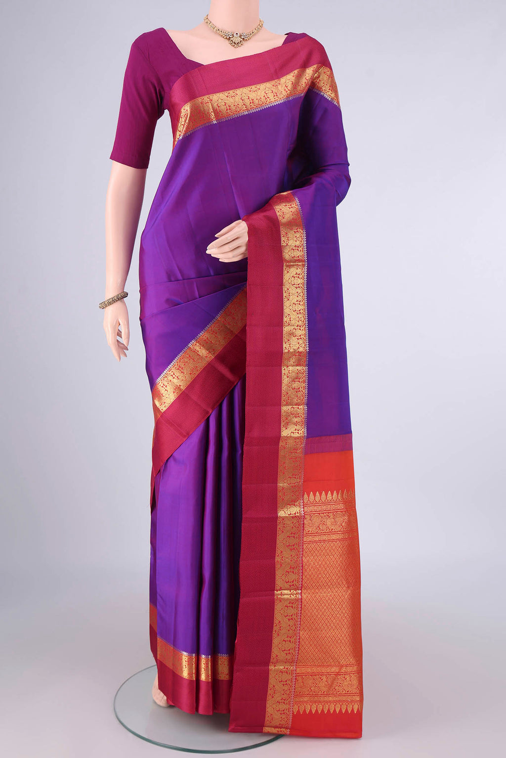 Pure Silk Purple Kanchipuram Saree with Plain Body and Zari And Thread Border.  displayed on a mannequin
