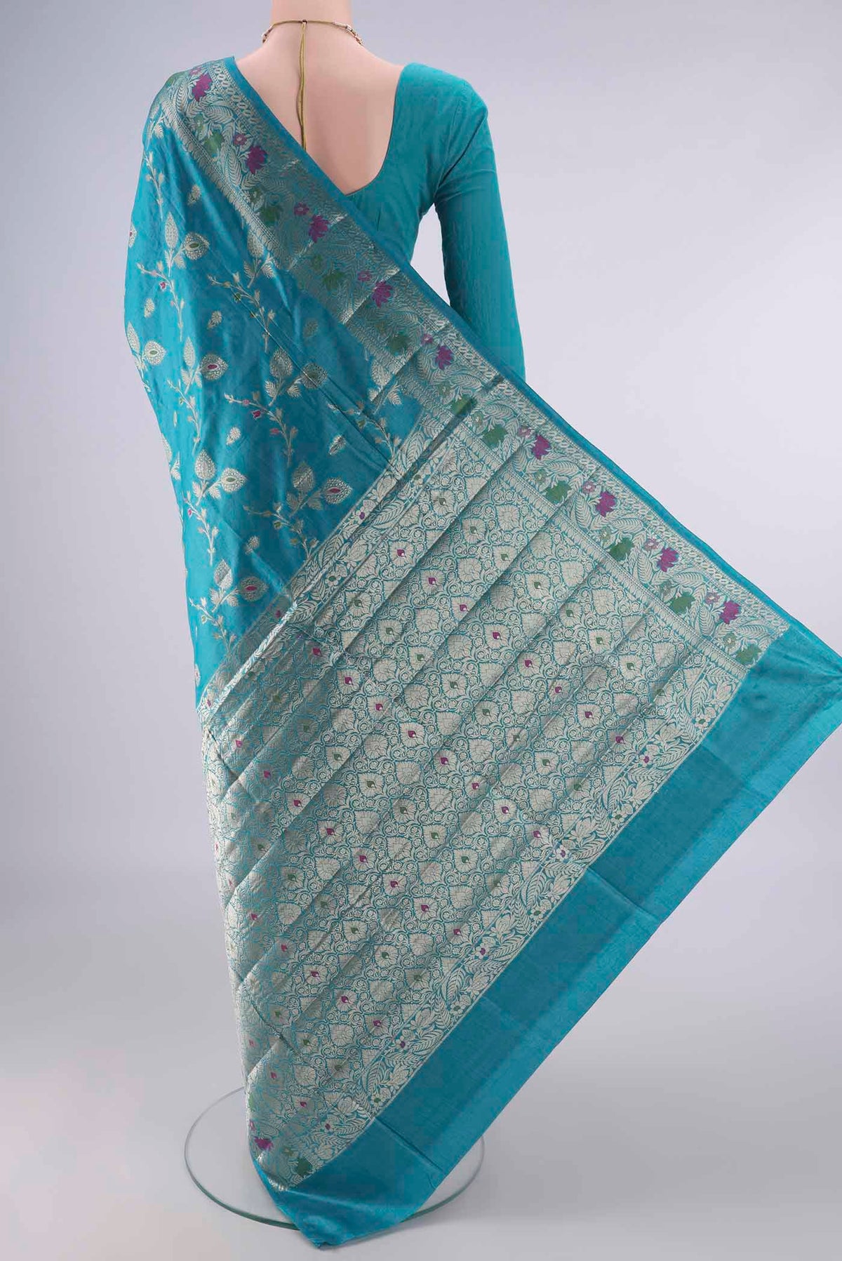 Flat view of Turquoise Banarasi Tussar Saree with Zari And Thread Butta on the body and Zari Border. 