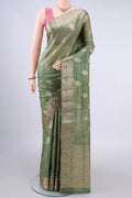 Light Green Banarasi Tussar Saree with Zari And Thread Butta on the body and Zari Border.  displayed on a mannequin