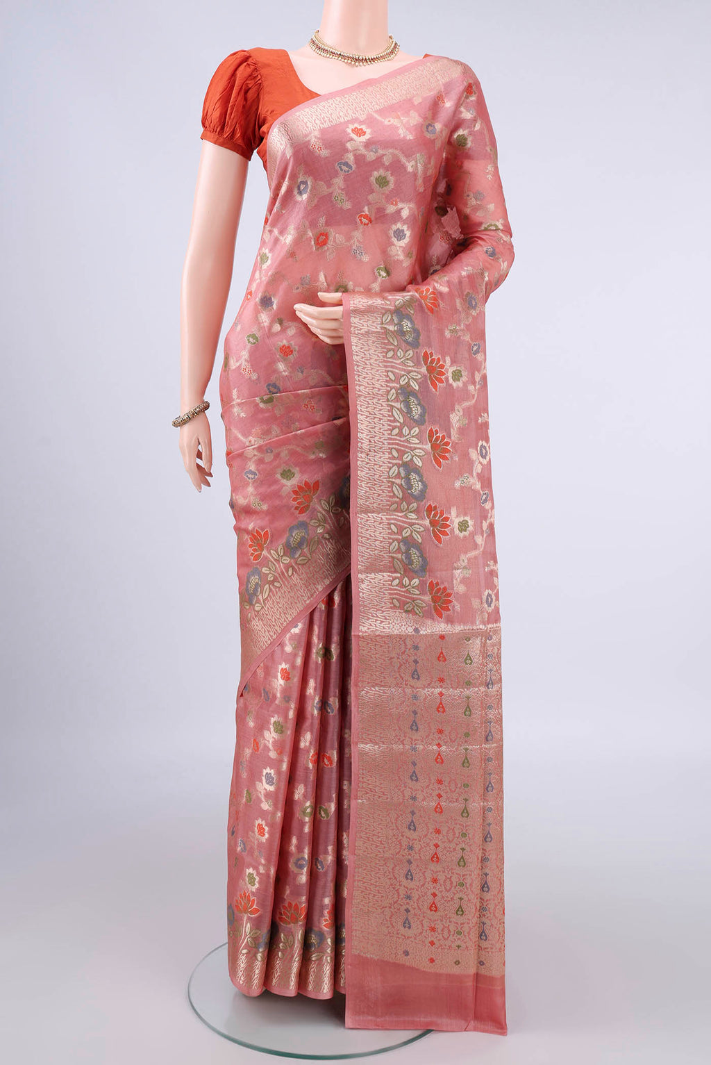 Peach Banarasi Tussar Saree with Zari And Thread Butta on the body and Zari Border.  displayed on a mannequin