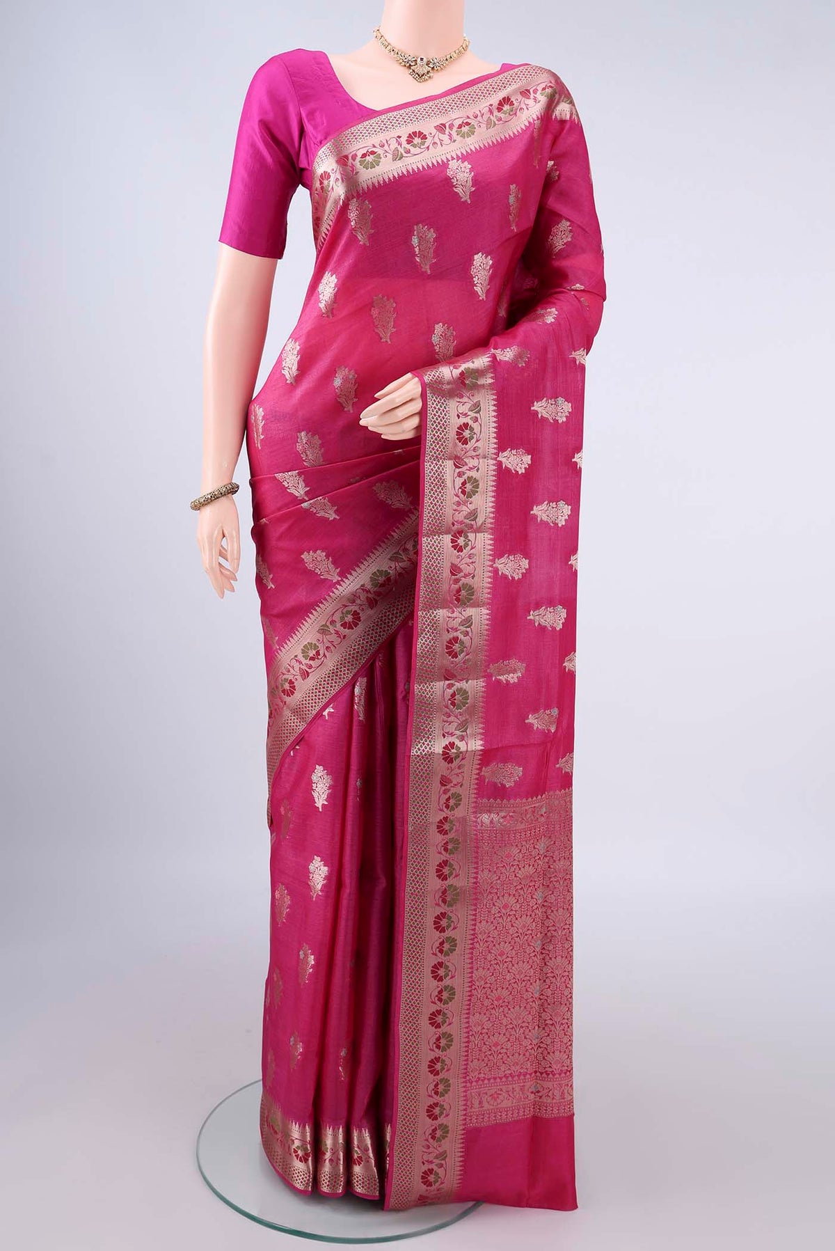 Rani Pink Banarasi Tussar Saree with Zari And Thread Butta on the body and Zari Border.  displayed on a mannequin