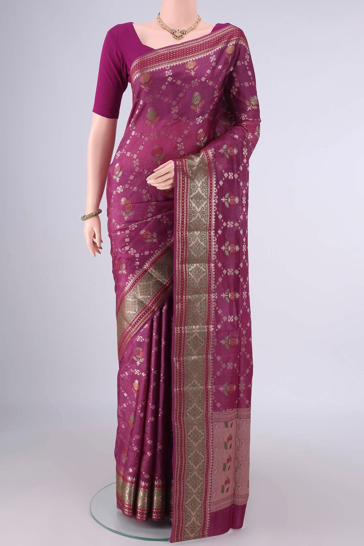 Magenta Banarasi Tussar Saree with Zari And Thread Butta on the body and Zari Border.  displayed on a mannequin