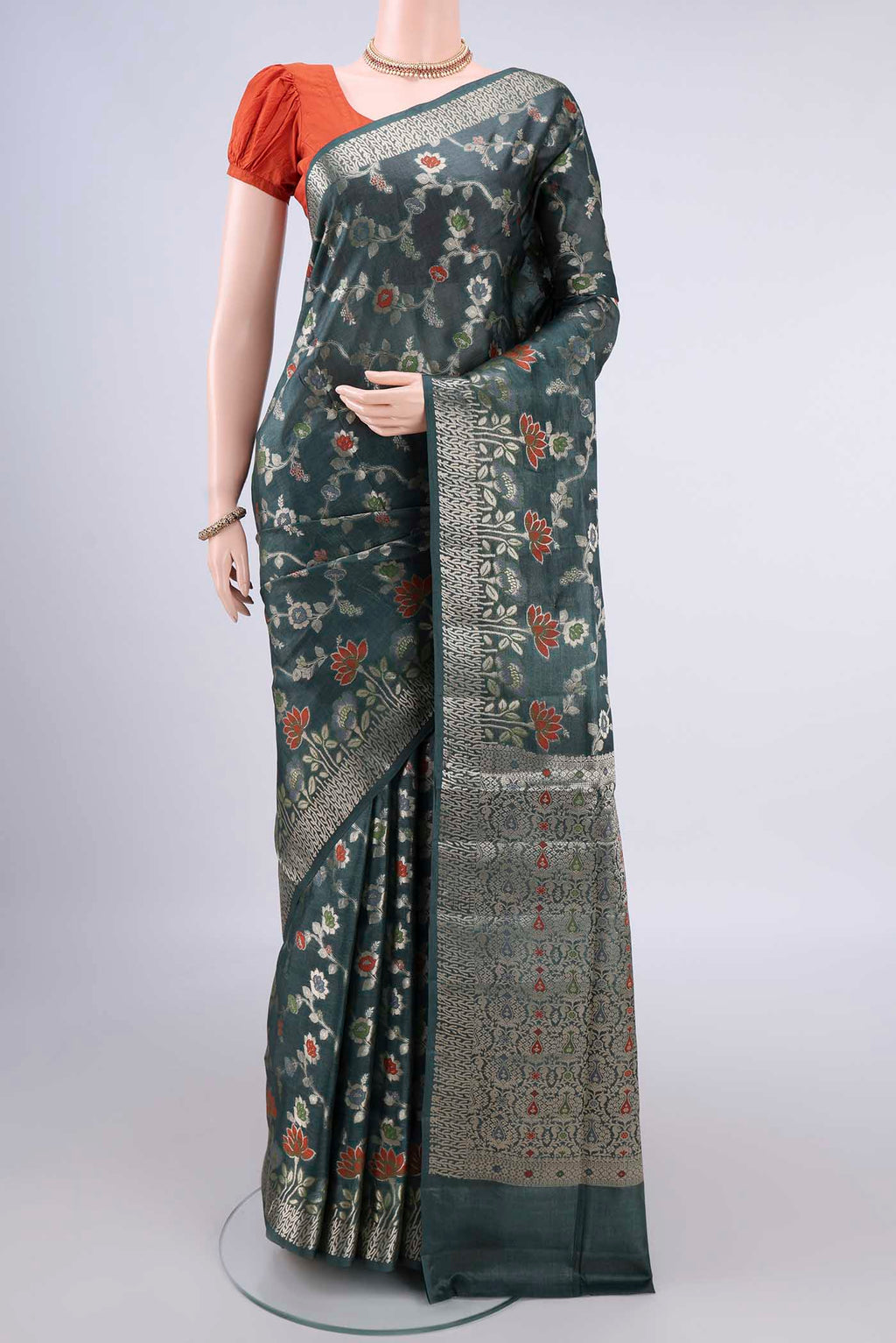 Olive Green Banarasi Tussar Saree with Zari And Thread Butta on the body and Zari Border.  displayed on a mannequin
