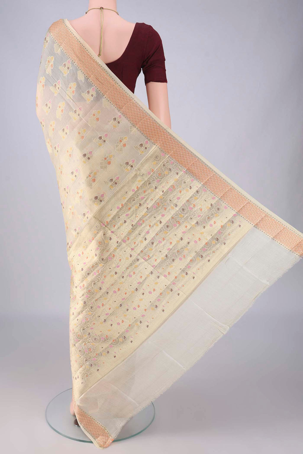 Flat view of Cream Banarasi Tussar Saree with Zari And Thread Butta on the body and Zari Border. 