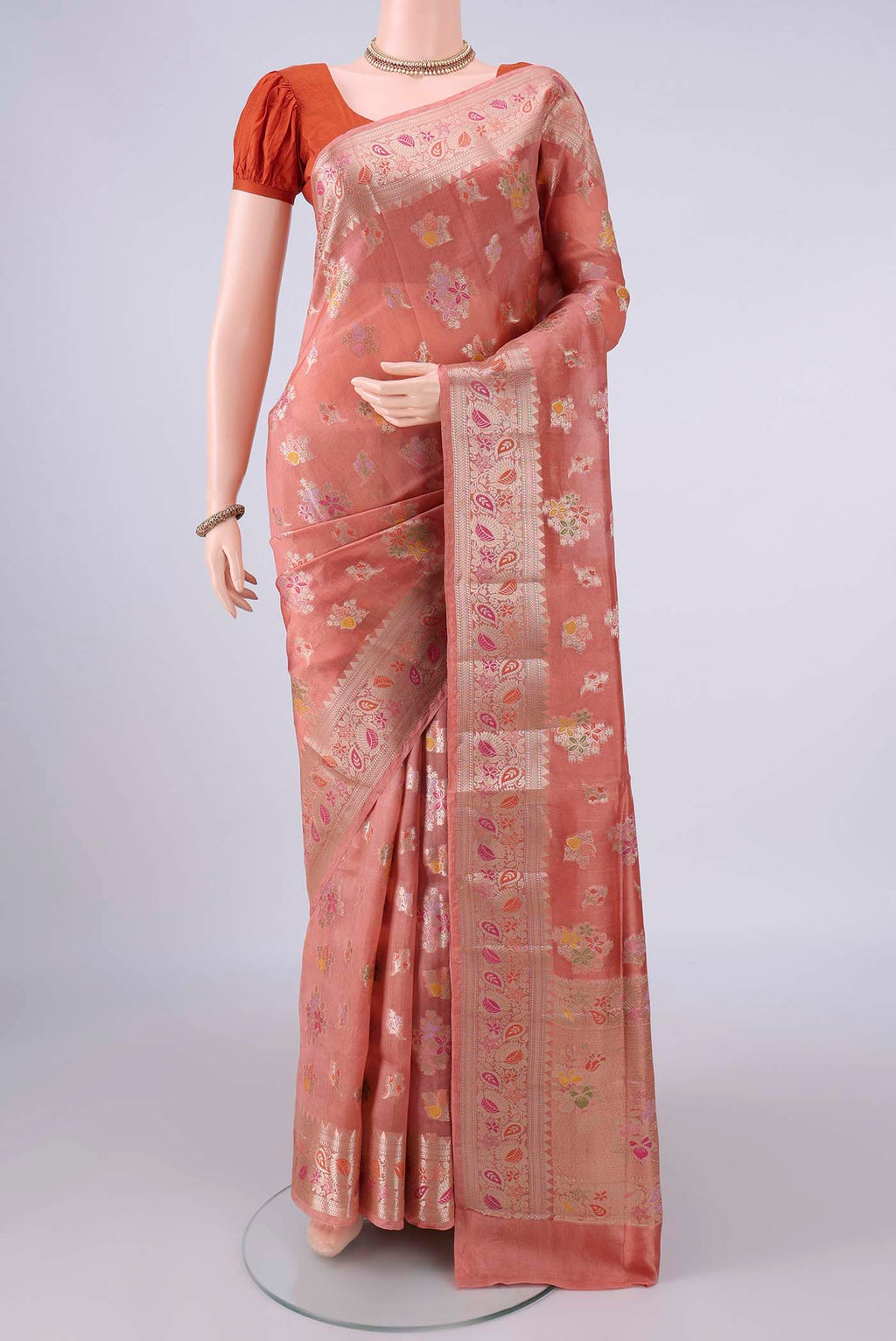Pure Silk Peach Banarasi Raw Saree with Zari And Thread Butta on the body and Zari And Thread Border.  displayed on a mannequin