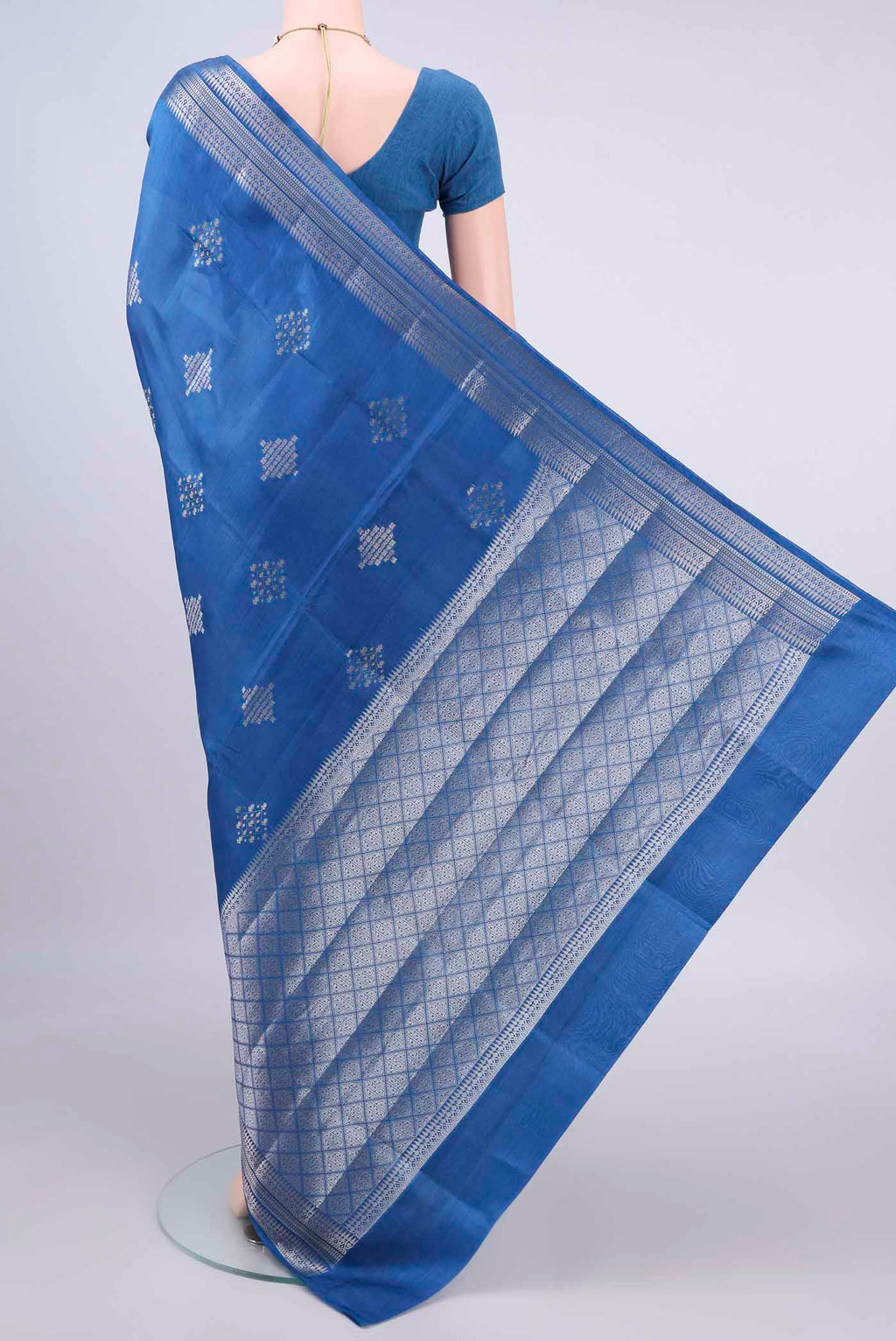 Flat view of Pure Silk Royal Blue Banarasi Raw Saree with Zari And Thread Butta on the body and Zari Border. 