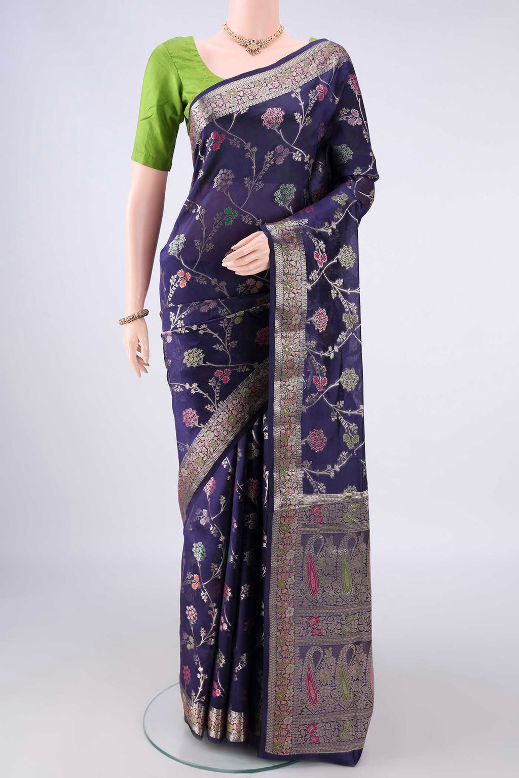 Pure Silk Navy Blue Banarasi Raw Saree with Zari And Thread Butta on the body and Zari Border.  displayed on a mannequin