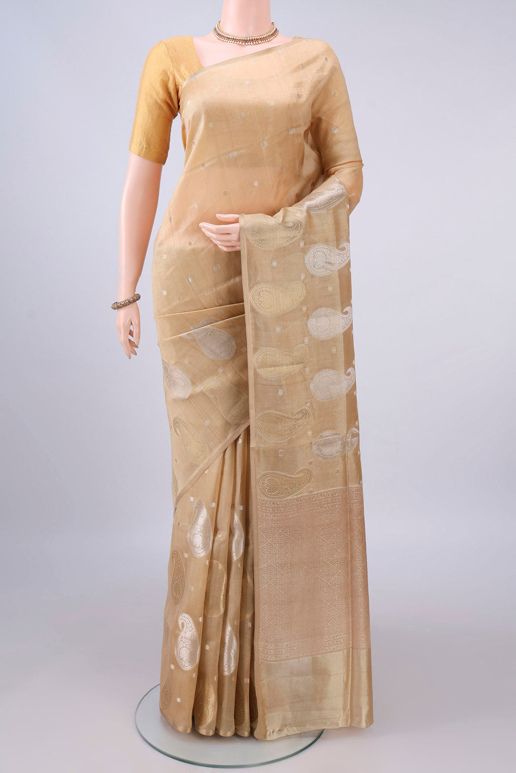 Pure Silk Sandal Banarasi Raw Saree with Zari And Thread Butta on the body and Without Border.  displayed on a mannequin