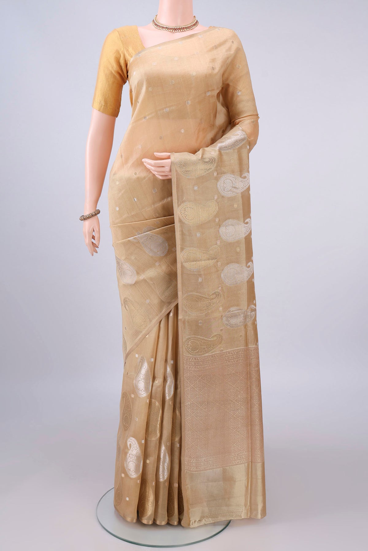 Pure Silk Sandal Banarasi Raw Saree with Zari And Thread Butta on the body and Without Border.  displayed on a mannequin
