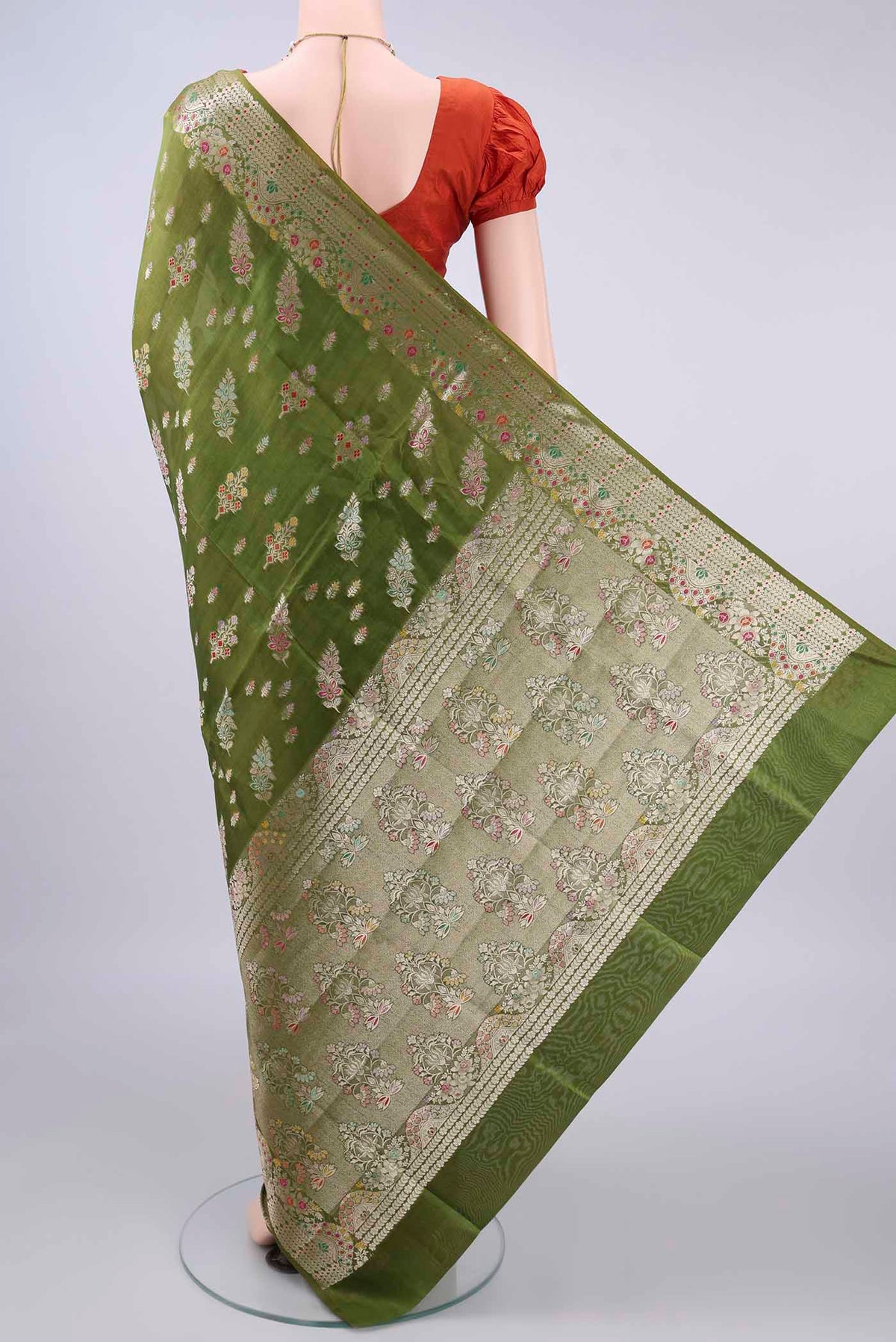 Flat view of Pure Silk Mehandi Green Banarasi Raw Saree with Zari And Thread Butta on the body and Zari Border. 