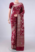 Pure Silk Maroon Banarasi Raw Saree with Zari Brocade on the body and Zari Border.  displayed on a mannequin