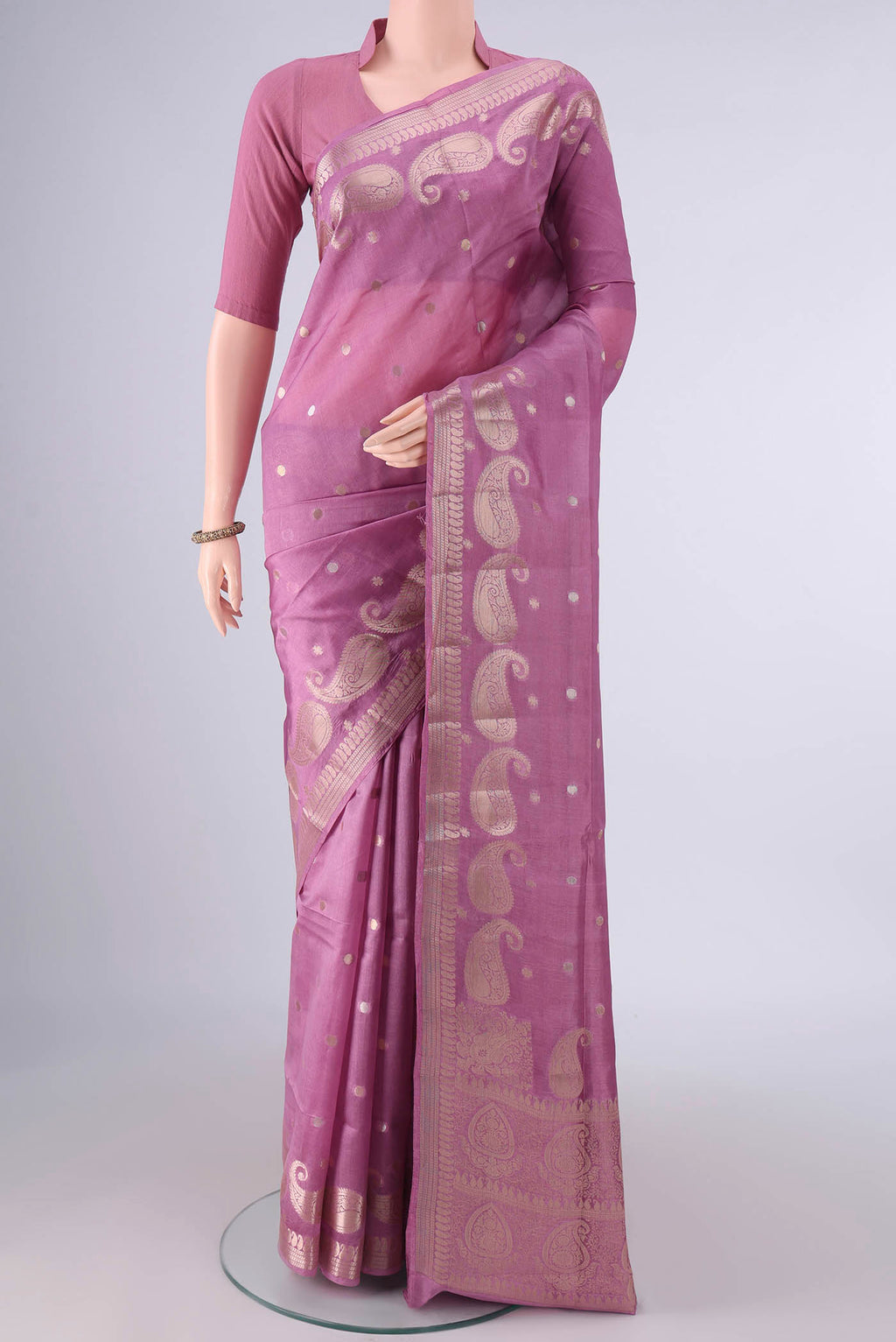 Pure Silk Rose pink Banarasi Raw Saree with Zari Butta on the body and Zari Border.  displayed on a mannequin