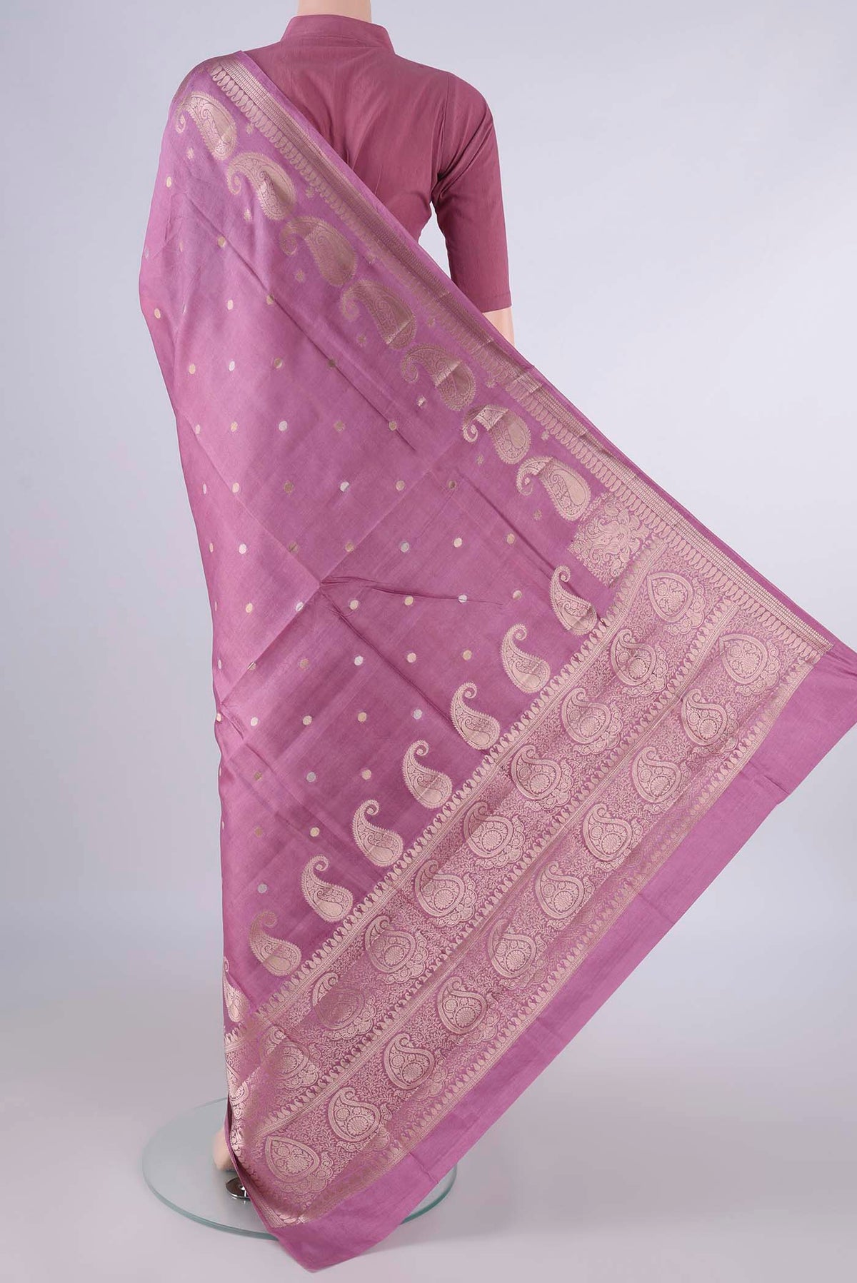 Flat view of Pure Silk Rose pink Banarasi Raw Saree with Zari Butta on the body and Zari Border. 