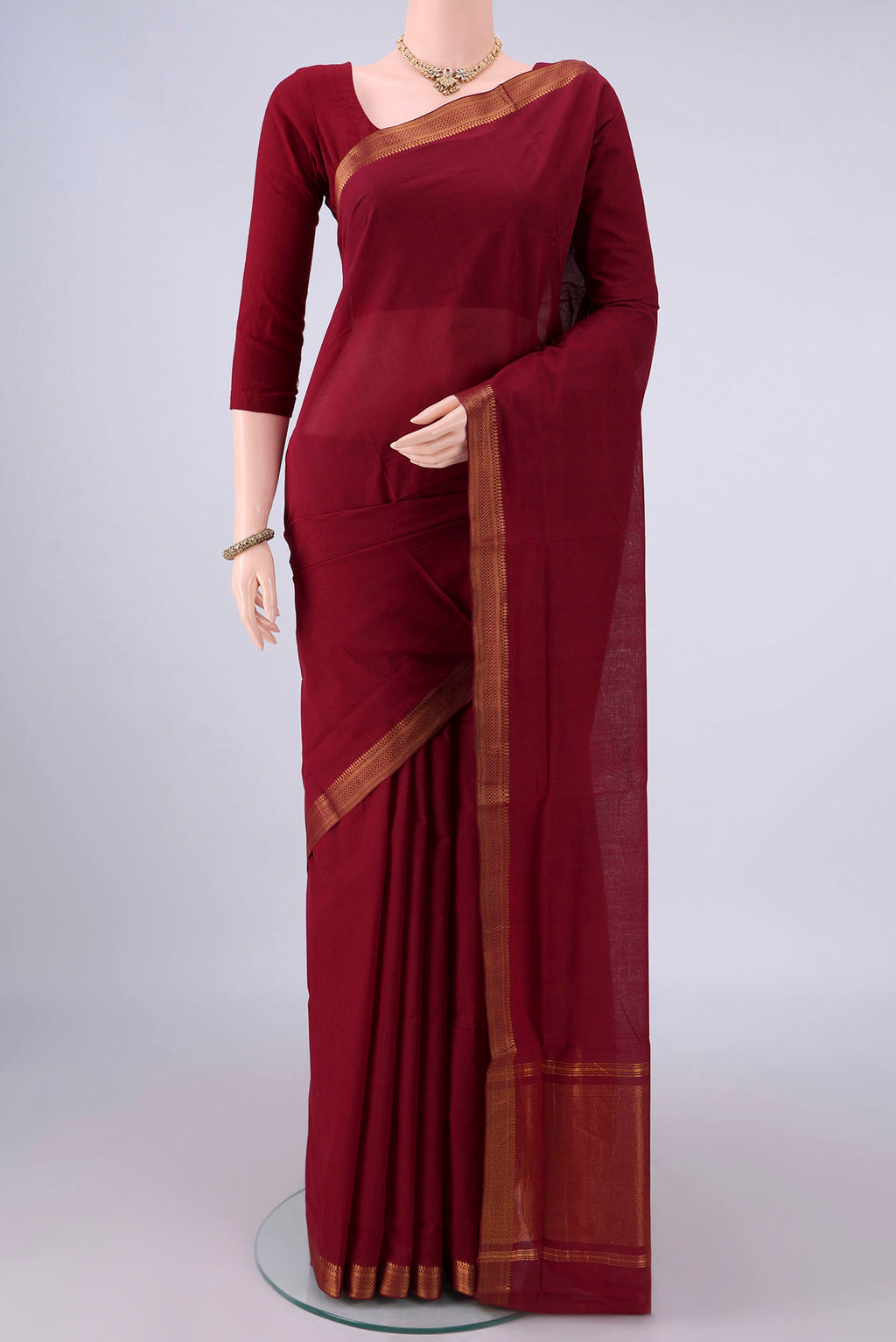 Maroon Mangalagiri Cotton Saree with Plain Body and Zari Border.  displayed on a mannequin