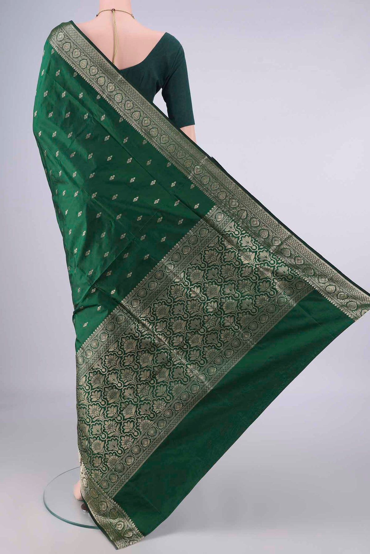 Flat view of Pure Silk Bottle Green Banarasi Katan Saree with Zari Butta on the body and Zari Border. 