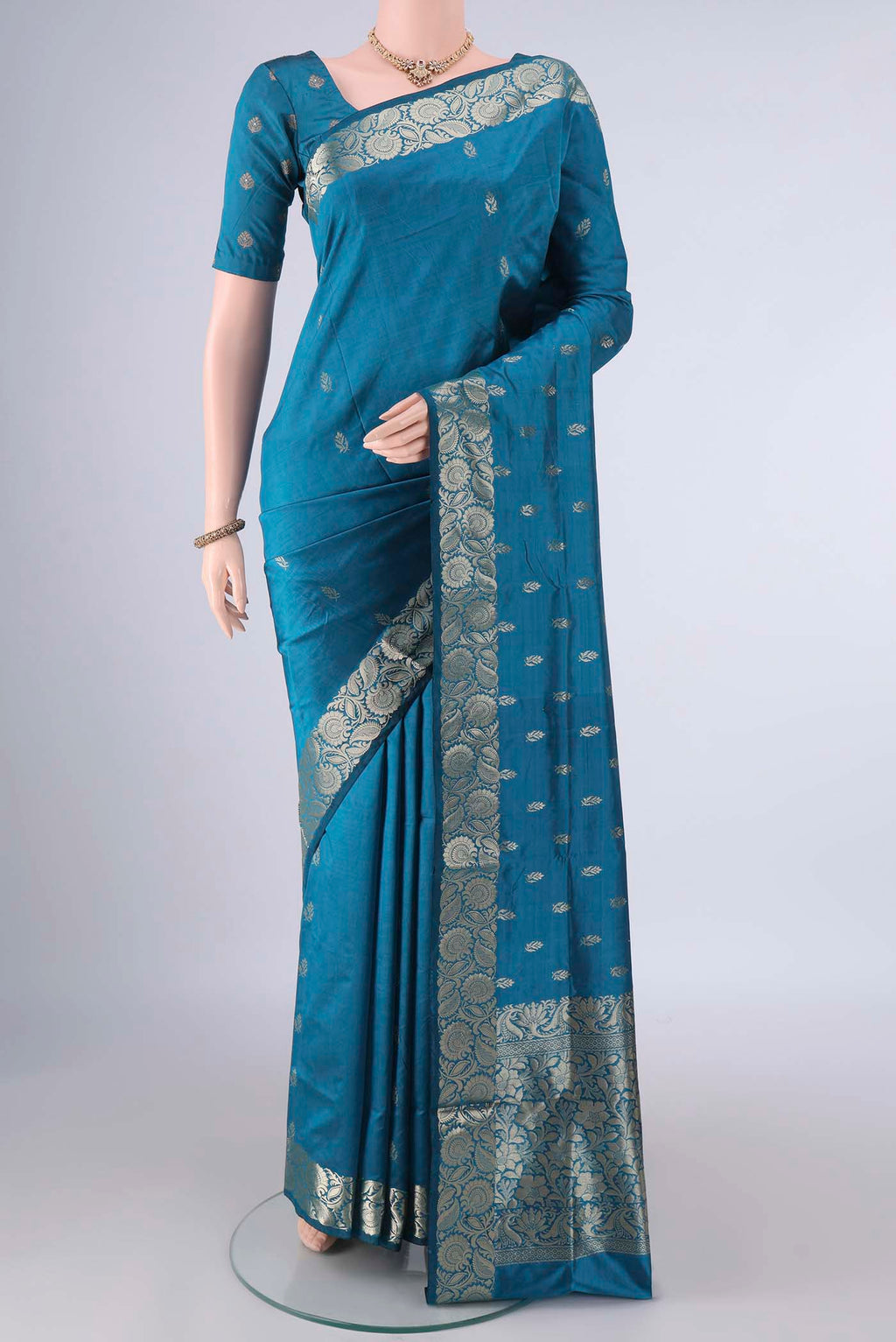 Pure Silk Blue Banarasi Katan Saree with Zari Butta on the body and Zari Border.  displayed on a mannequin