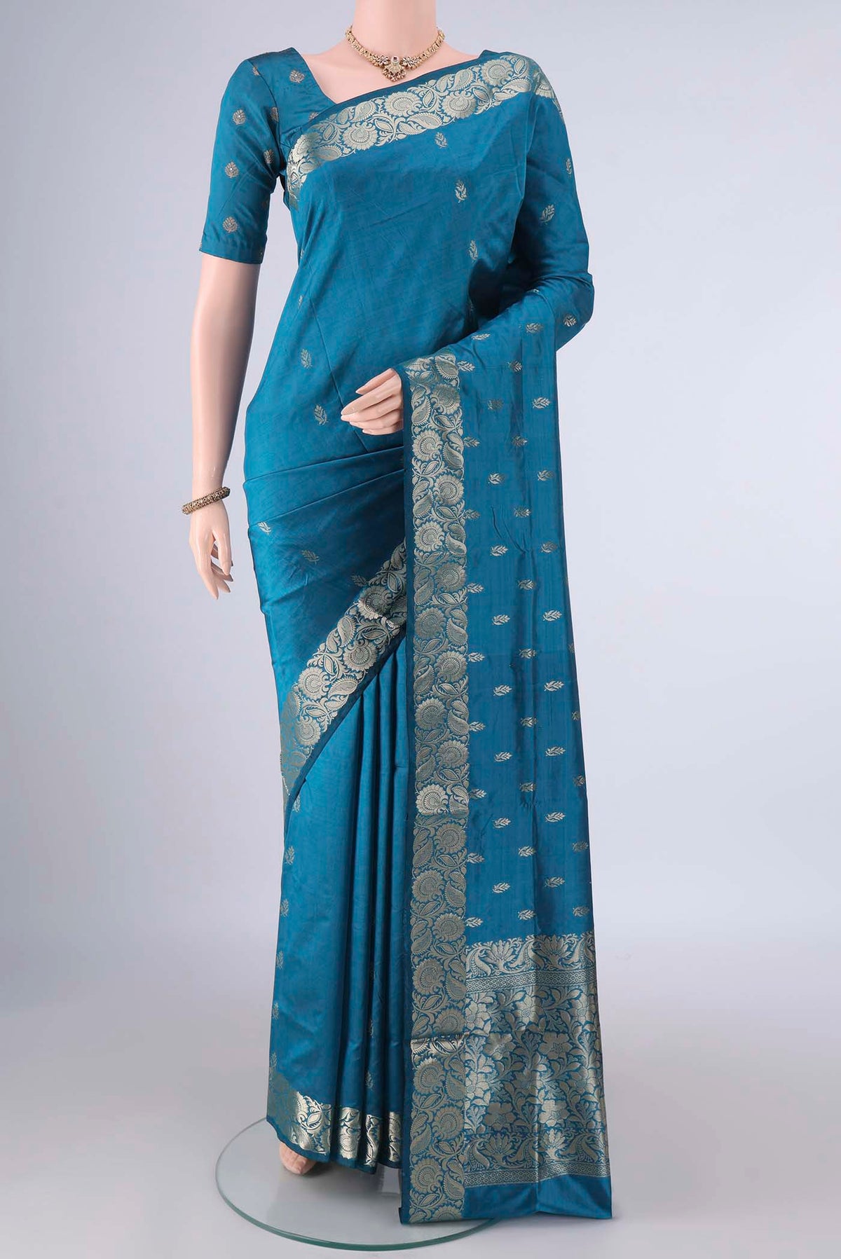 Pure Silk Blue Banarasi Katan Saree with Zari Butta on the body and Zari Border.  displayed on a mannequin