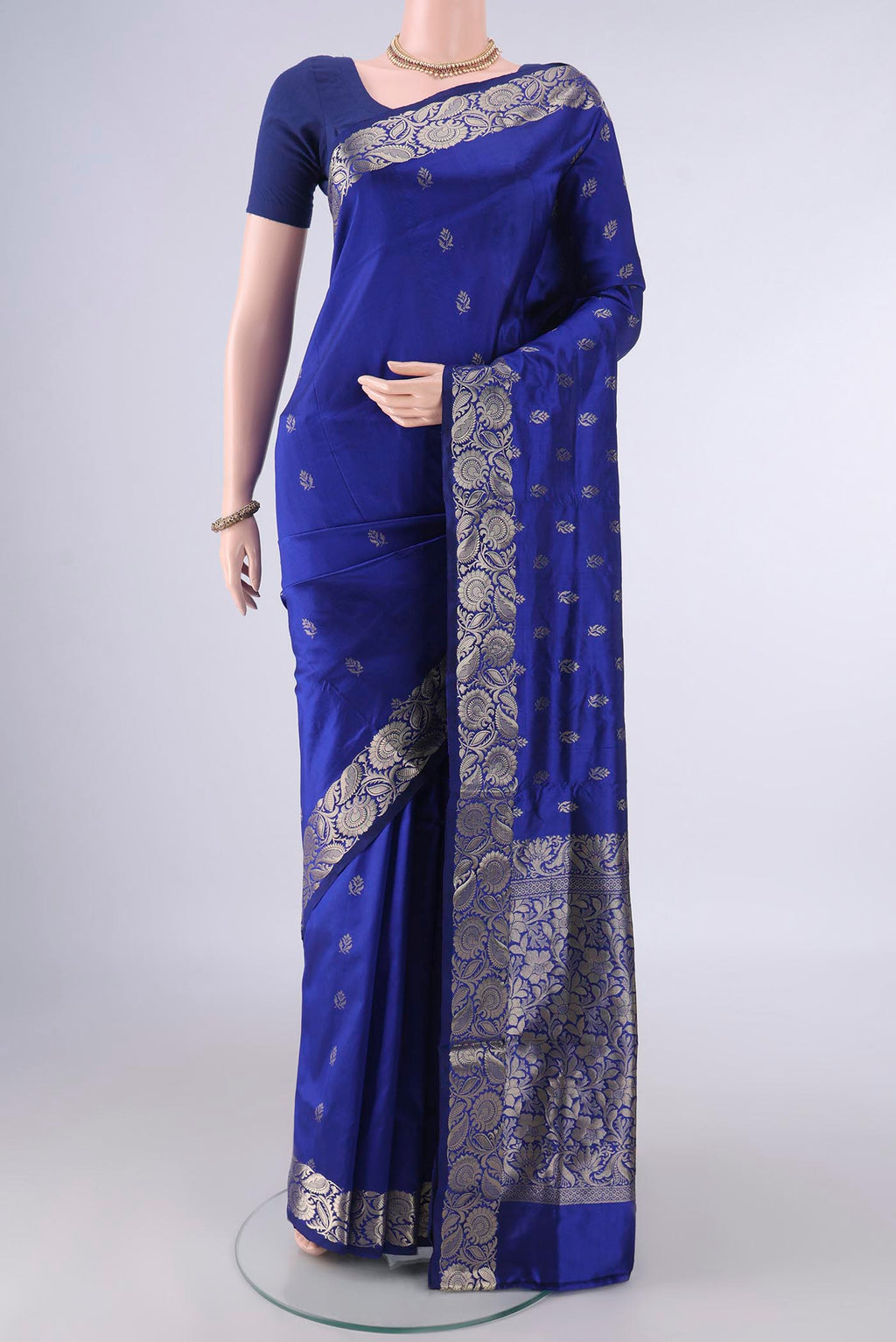 Pure Silk Royal Blue Banarasi Katan Saree with Zari Butta on the body and Zari Border.  displayed on a mannequin