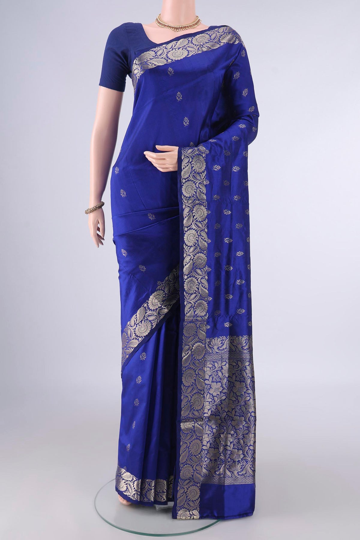 Pure Silk Royal Blue Banarasi Katan Saree with Zari Butta on the body and Zari Border.  displayed on a mannequin