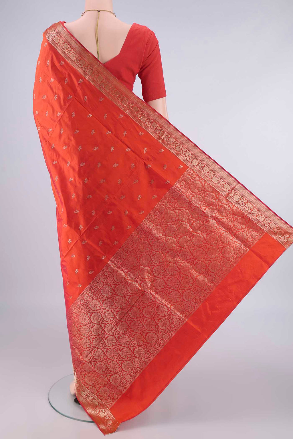 Flat view of Pure Silk Brick Orange Banarasi Katan Saree with Zari Butta on the body and Plain Border. 