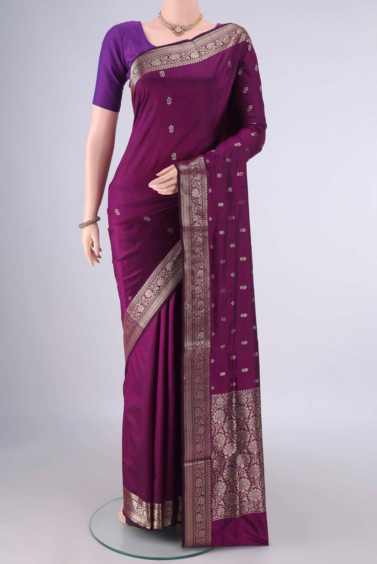 Pure Silk Burgundy Banarasi Katan Saree with Zari Butta on the body and Zari Border.  displayed on a mannequin