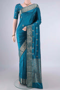 Pure Silk Peacock Blue Banarasi Katan Saree with Zari Butta on the body and Zari Border.  displayed on a mannequin