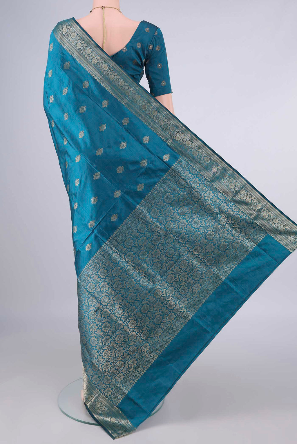 Flat view of Pure Silk Peacock Blue Banarasi Katan Saree with Zari Butta on the body and Zari Border. 