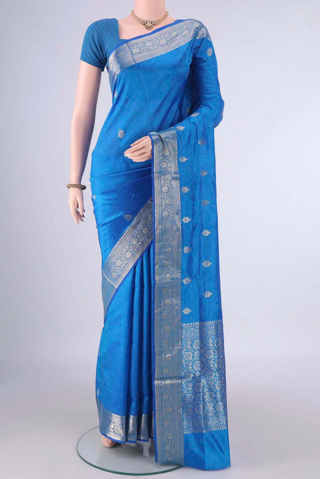 Pure Silk Electric Blue Banarasi Katan Saree with Zari Butta on the body and Zari Border.  displayed on a mannequin
