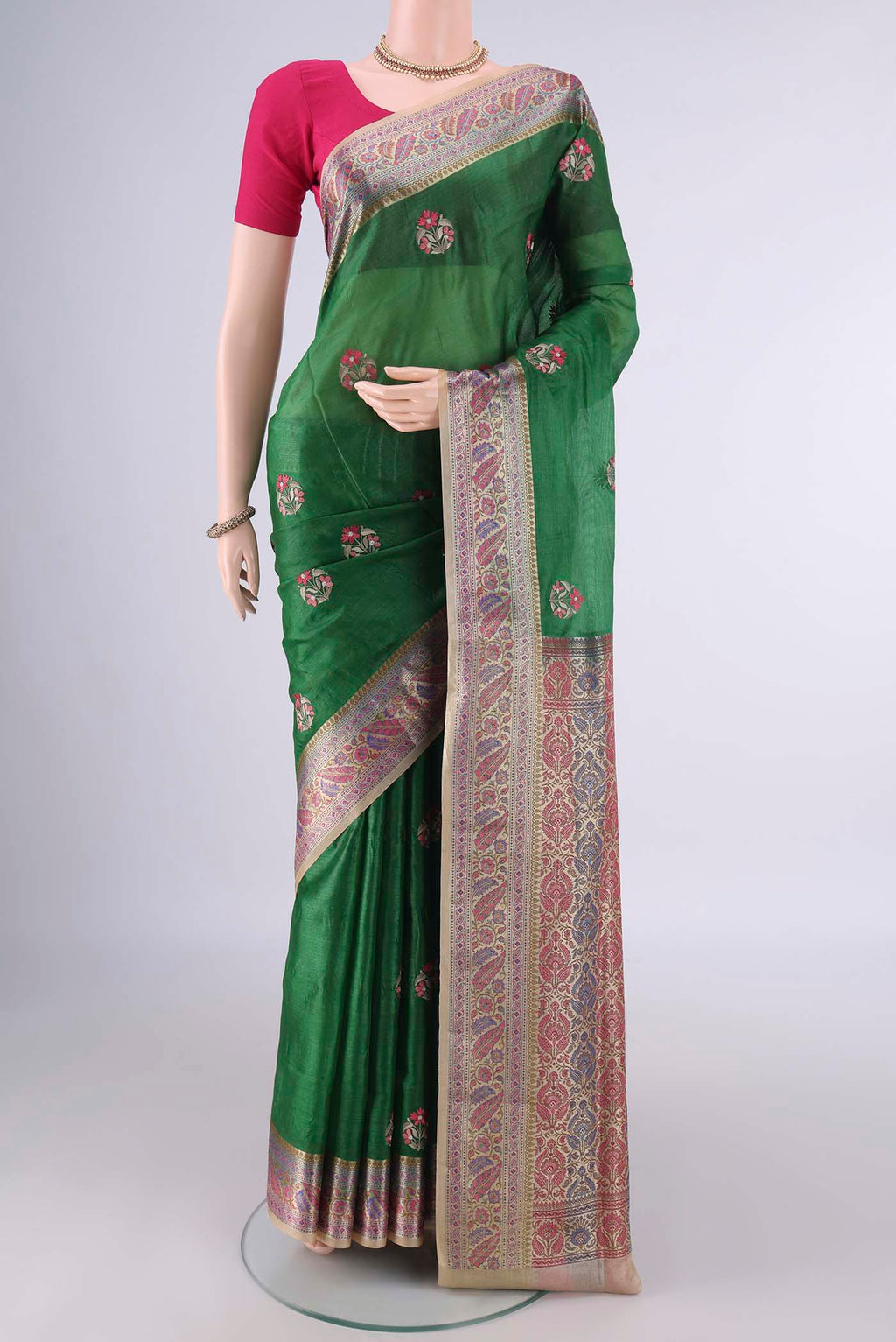 Green Banarasi Tussar Saree with Embroidery on the body and Zari Border.  displayed on a mannequin