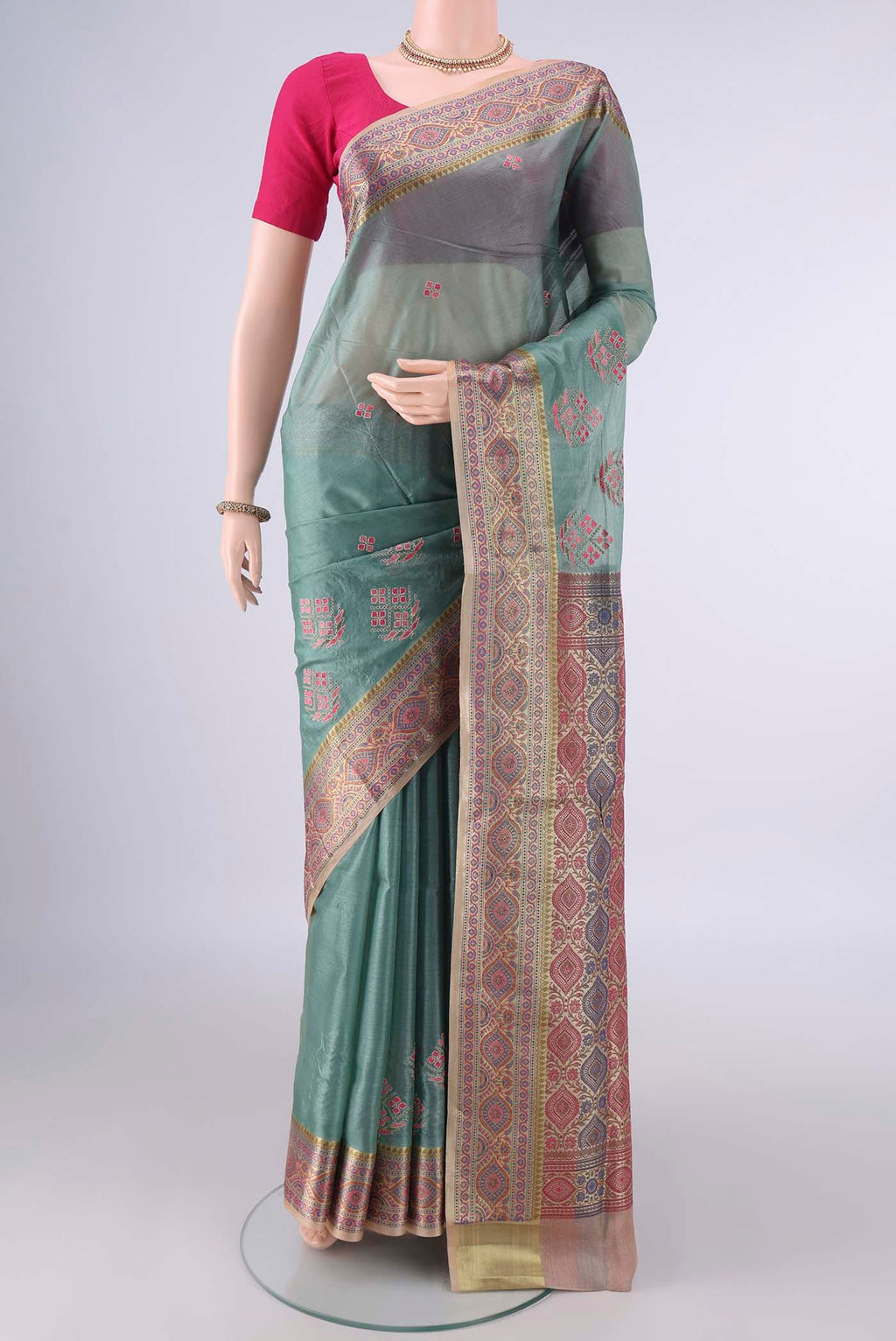 Light Green Banarasi Tussar Saree with Embroidery on the body and Zari Border.  displayed on a mannequin