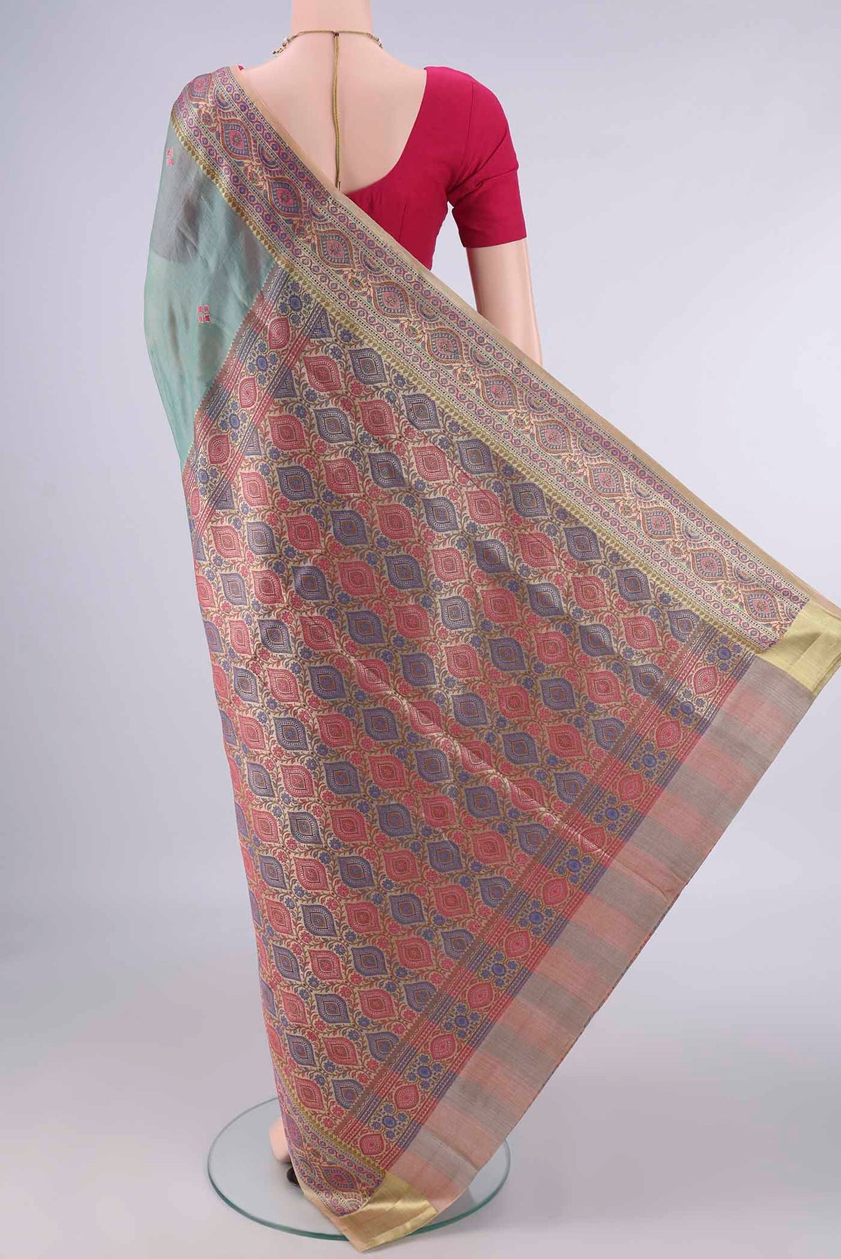 Flat view of Light Green Banarasi Tussar Saree with Embroidery on the body and Zari Border. 
