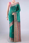 Sea Green Banarasi Tussar Saree with Embroidery on the body and Zari And Thread Border.  displayed on a mannequin