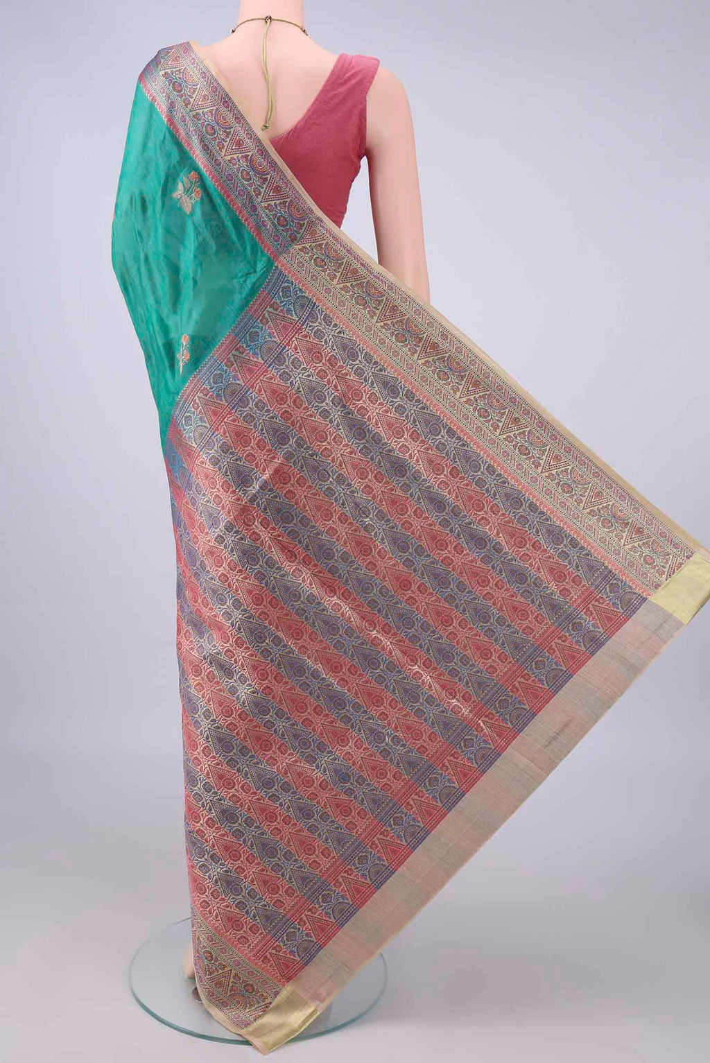 Flat view of Sea Green Banarasi Tussar Saree with Embroidery on the body and Zari And Thread Border. 