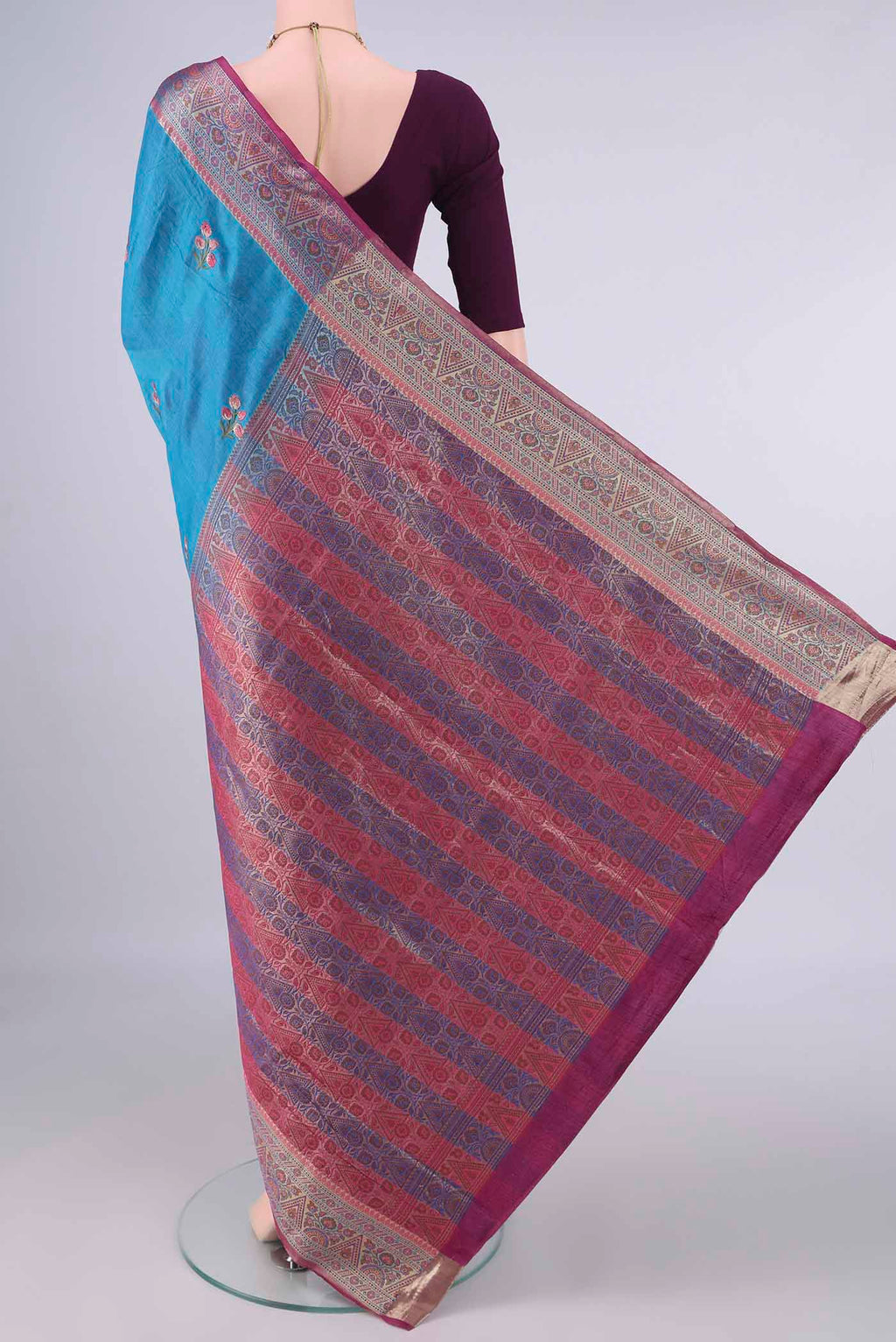 Flat view of Blue Banarasi Tussar Saree with Embroidery on the body and Zari Border. 